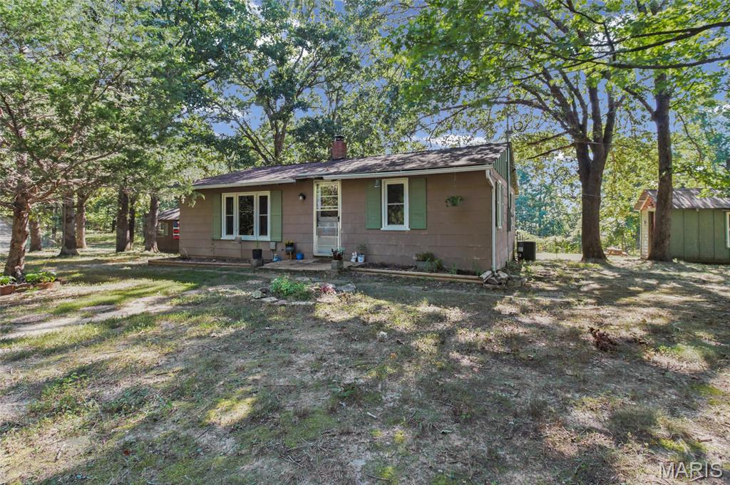 Don't miss the opportunity to see this almost 11 acre farm in Sullivan! Charming country home with possibilities galore!! Primary residence or weekend getaway. This place is super cute and has potential to be anything an owner could want. This darling home has the original metal cabinets, porcelain sink and some wood floors. Don't forget the wood burning fireplace and a sunroom off the back that you will love. There is a bonus room which has been used as a small 2nd bedroom. The grounds have been loved and diligently cared for for over 3 decades. Every direction you turn you see open spaces, woods, greenery - you name it!  The barn has 2 stalls with the potential for a third. Incredible location just minutes from Pea Ridge Conservation offering over 1045 acres of recreation and outdoor fun including amazing rivers and creeks. Starlink ready!! All appliances and gun safe will stay. Make your appt today, a deal like this won't last long!! :)
