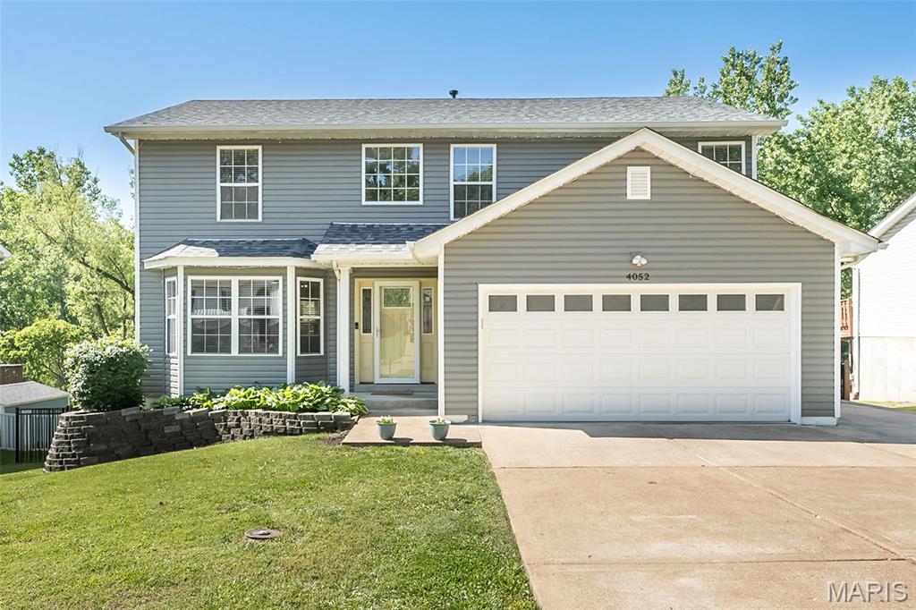 4052 Whitehall Dr. isn’t just a bigger house. It’s the kind of home families move into when life starts getting fuller, louder, and better. The kind where bikes end up scattered in the driveway, soccer balls live in the backyard, and summer nights stretch a little longer because nobody wants to go inside.

Tucked against woods and common ground, the backyard feels private in a way that’s getting harder to find. Instead of staring into another row of houses, your kids are chasing fireflies, kicking a ball across open green space, building forts near the trees, and actually playing outside again. There’s room here for the family football game after Thanksgiving dinner, a giant Slip ’N Slide in July, or a fire pit with neighbors while the kids run until dark.

And the oversized cedar deck? That’s where this house really comes alive.

Morning coffee before the house wakes up. Birthday parties. Burgers on the grill while somebody’s playlist drifts through the backyard. Parents gathered around the table talking long after dinner while kids roast marshmallows nearby. It’s not just outdoor space — it’s the backdrop for the memories your family will talk about years from now.

Inside, everything feels like the upgrade your growing family has been craving. More room to spread out. More room to breathe. More room for everybody to have their own space without losing the feeling of togetherness. Whether it’s movie nights in the family room, homework at the kitchen counter, sleepovers downstairs, or holiday chaos that somehow becomes your favorite memories, this home was built for real family life.

And unlike so many homes in this price range, the big-ticket work is already DONE.

The roof, siding, and gutters are just one year old. New flooring runs throughout the home. Fresh paint, updated lighting, fixtures, and faucets mean you’re not inheriting somebody else’s to-do list. You can move in, unpack, and immediately start living instead of spending every weekend at Home Depot.

One of the most unique features is the dedicated side parking pad — perfect for a boat, camper, or travel trailer. This is the kind of house for a family that actually uses weekends. Saturdays at the lake. Camping trips. Last-minute road trips. Bikes loaded up and gone by sunrise. The extra space makes those adventures easy instead of complicated.

The neighborhood itself feels like the kind of place people hope their kids grow up in. Walkable streets. Friendly neighbors who actually know each other. Halloween nights with fire pits glowing in driveways while kids run house to house. Annual garage sales that feel more like community events. Quick access to Mastodon State Historic Site’s walking trails and creek adventures when the kids need to burn energy. The Arnold Farmer’s Market, shopping, restaurants, library, and daily conveniences are all nearby without sacrificing the quieter feel of home.

Families also love the highly regarded Fox C-6 School District, including Hodge Elementary and Antonia Middle School, known for smaller class sizes, caring teachers, strong after-school programs, and youth sports that help kids build friendships and confidence beyond the classroom.

This is the kind of move-up home that changes how a family lives day to day. More freedom. More connection. More space for kids to simply be kids.

And years from now, when your children talk about “the house they grew up in,” this feels like the kind of place they’ll remember.