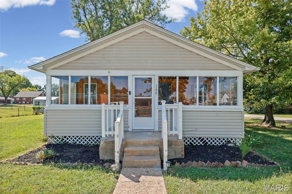 Charming 2-bedroom, 1-bath home situated on a spacious corner lot! This move-in ready property features beautiful hardwood flooring in the living room, dining room, and bedrooms, fresh paint, and an inviting enclosed front porch. Enjoy additional living space in the sunroom that opens to a deck overlooking the nicely landscaped yard. Recent updates include a newer furnace, water heater, refrigerator, roof (2024), gutters with leaf guards, sump pump, some windows, and cleaned ductwork. Additional improvements include a French drain, updated downspouts with underground drainage, and basement foundation enhancements. The unfinished basement provides plenty of storage, while the partially finished upper level offers potential for a 3rd bedroom, office, or bonus space. Storage shed included. Convenient location near schools and town amenities. Don't miss this opportunity to own a home that offers both character and peace of mind with numerous updates already completed! Showings start Friday the 11th.