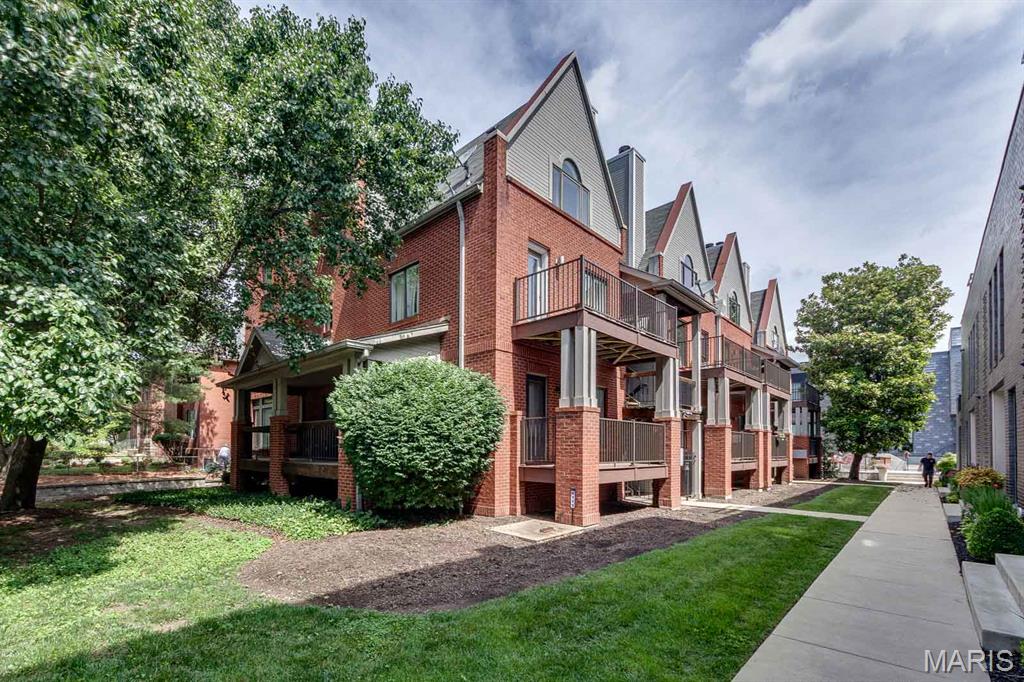 This 2-bed, 2-bath gem is tucked away on a quiet, low-traffic street in the vibrant Central West End neighborhood.  You will love the open floor plan with the seamless flow between the nice size kitchen-complete with stainless appliances and a breakfast bar-and the spacious living area. The black marble wood burning fireplace invites a cozy evening at home. Enjoy a cool drink on the newly renovated balcony on a hot summer evening, or retreat to the primary suite featuring a walk-in closet and a luxurious jetted tub after a long day. With in-unit laundry and two tandem garages spaces included, this condo checks everybox for stylish city living. BRAND NEW HVAC INSTALLED 06/2026. Low condo HOA fees, near transportation,park, hospital and retail/restaurants