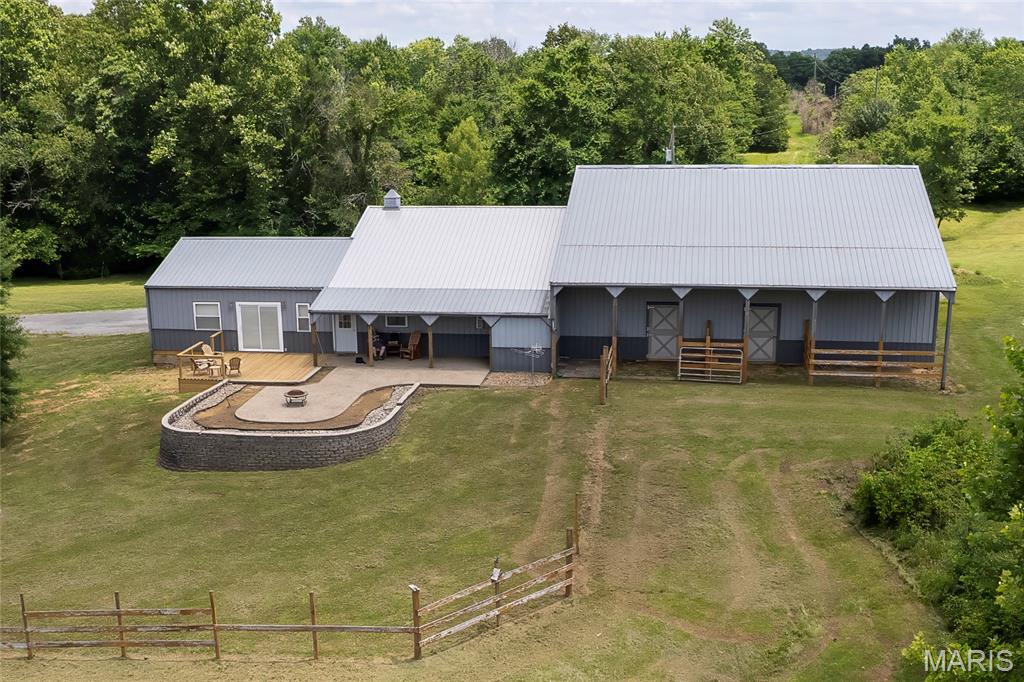 RARE OPPORTUNITY to live right across the road from The Shawnee National Forest!! Home is 12 minutes from Garden of the Gods! No need to bring a horse trailer-you can ride your horses right down the driveway and into the miles and miles of Shawnee National Forest horse trails! Meticulous  home on 9 pristine acres w/horse barn! This move-in ready home features wood ceilings, log paneled walls & large outdoor spaces for entertaining family & friends! Make this your year round home or a perfect opportunity for a short term rental investment. The trails are already mowed for you, just waiting for you to being your horses or your side by side. Great hunting and trail riding awaits you! Outside, you'll love the huge raised aggregate patio w/firepit overlooking the property, the covered porch and the new deck! Horse barn (60' x 36') is attached to the back of the 32' x 24' garage. (Stalls have been removed) Don't let this one get away!