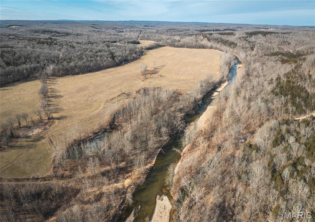 This is a rare opportunity to own 94.55 +/- acres with approximately 2,900 feet of Mineral Fork water frontage. The property is made up mostly of open pasture, offering wide-open views and a very usable layout, with a small pond providing an additional water source. The long, winding stretch of Mineral Fork features multiple access points and gravel bars, making it an ideal place for family and friends to gather during the summer months to fish, swim, or simply enjoy time by the water. Properties with this much water frontage, open ground, and location are hard to find. Whether you’re looking for a place to build, hunt, run livestock, or create a family retreat along the water, this tract offers a combination of features that are rarely available in one property. 
Electric is nearby, offering multiple building opportunities for a home, cabin, or weekend getaway. Several potential building sites overlooking the surrounding countryside. While the property feels private and secluded once you’re on it, it is conveniently located just off Highway 47, providing easy access year-round. 
The open pasture is bordered by timber, creating privacy and excellent edge habitat for wildlife. This natural setup provides strong hunting opportunities, with the timbered edges acting as natural travel corridors. The mix of open ground and cover also makes the property well suited for recreational use, livestock, horses, or ATV riding.