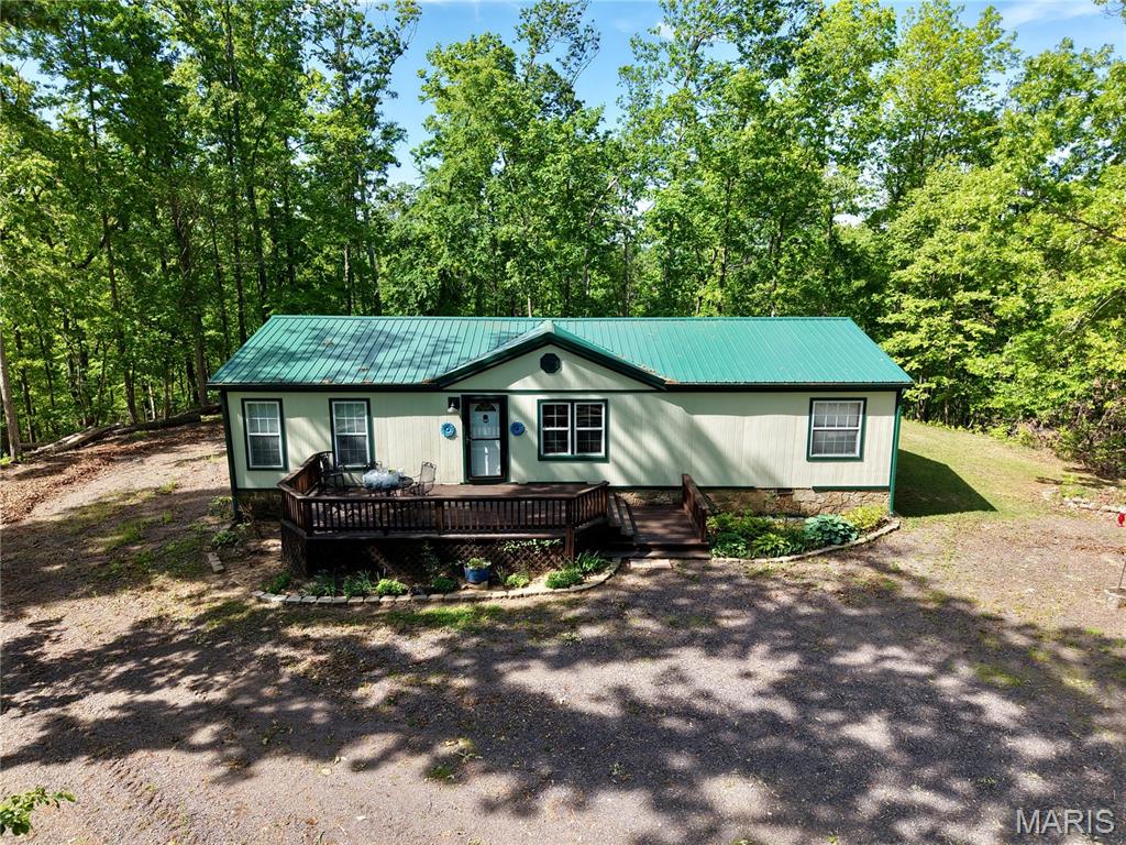 Don’t miss this opportunity to own 28.5 acres of wooded ground just minutes from Clearwater Lake! This 3 bed, 2 bath mobile home sits on a solid concrete slab with stone and concrete skirting and features a new roof, newer siding, and updated cabinets and countertops. The wooded acreage provides excellent privacy and natural cover, while adjoining government ground expands your access to outdoor recreation. A 30x50 shop with water and electric, offers plenty of room for equipment, boats, or hobbies. Ideal for a full-time residence, weekend escape, or recreational property.