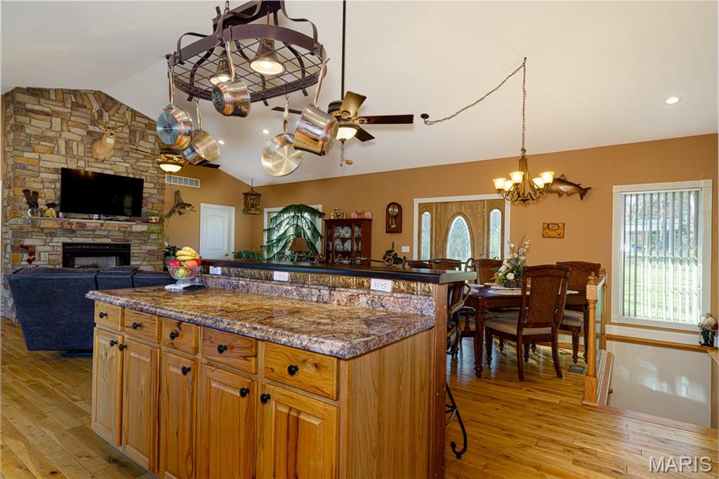 FAR AWAY OFF THE ROAD, HIDDEN IN A ALCOVE Finds this stunning custom built home by very talented Builder for his own personal use.  7 Dashing Acres with view-fest before you off the massive deck or patio, you cannot look out a window without the site of the Countryside.  2 bedrooms, 2.5 bath represents the best of life.  Cathedral Ceilings not only make focus on the beautiful fireplace they also have can lighting and a lit Ceiling fan shining on those simply gorgeous Floors.  There is a 1/2 bath for guest or game night handy.  This kitchen calls for a cook with a talent to put out the finest foods which is also open to the living room, front covered porch and back deck.  An Island makes use of seating or tons of space for gathering during large crowds.  There is a clever spot for a Dining room.  The Master is simply lush experience to lounge in. This en suite provides a private privy with a view.  The attached garage is a delight with great lighting, a sink and storage just what you ask for.  Down in the full walkout basement finds a perfect bar overlooking the beautiful countryside view, large space for your clan to gather, a darling bedroom with a Jack & Jill bathroom to share but lock for privacy.  This room is cozy and safe.  Hurry up, this won't last long.