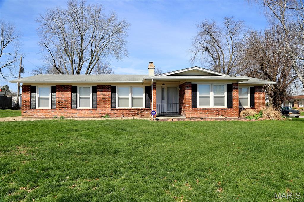 SPOTLESS & MOVE-IN-READY! 3BR/2BA RANCH! CORNER LOT, QUIET NEIGHBORHOOD! Enter off the covered porch into the spacious foyer with ceramic tile flooring and large closet. Living room is to the right with 2 large windows, filling the room with lots of natural light. Family room is to the left with 2 more large windows, beautiful wood flooring, ceiling fan, and fireplace with floor-to-ceiling brick. Eat-in kitchen is adjacent and was completely updated in 2024 with new cherry cabinets, new quartz counters with subway tile backsplash, new lighting, and new electric range, microwave, dishwasher, and disposal. Newer wood flooring in hallway leads to 3 bedrooms, including primary bedroom with private full bath. Second full bath in the hall. Both baths have updated vanities. Home boasts a rear-entry, oversize 2 car garage (27' x 20') with heater and 2 ceiling fans; two windows let in lots of natural light. Full unfinished basement provides lots of potential additional living space; washer/dryer hook-ups + sink; laundry chute in upstairs hallway. Newer insulated windows with tilt-in feature; newer blinds throughout. Carpet replaced in 2022. New HVAC in 2019. Electric panel replaced in 2024. Level lot. Portion of backyard is fully fenced. Shed. Security system. MUST SEE!