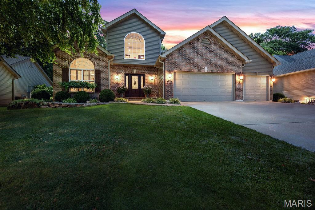 Eperience exceptional living in this impeccably maintained home nestled on a quiet cul-de-sac in highly desirable Highland Forest. Thoughtfully designed with timeless style and effortless functionality, this home offers the perfect blend of refined finishes and inviting living spaces. From the moment you enter, you'll be captivated by the home's light filled interior, enhanced by plantation shutters, striking stone accents, and custom built-ins that add architectural character and sophistication throughout. Designed with entertaining in mind, the expansive dining room comfortably accommodates large gatherings, while the professionally finished lower level offers an exceptional extension of the home. Complete with a bonus room, full bath, kitchenette, and generous recreation space, it's ideal for hosting family and friends. The included game tables (pool table, air hockey, foosball, shuffleboard) make this level ready for entertaining from day one! The kitchen features elegant stone countertops, a designer backsplash, and new stainless-steel appliances. Step outside to your own private outdoor retreat, where a lush tree-lined backdrop creates a peaceful setting. Enjoy the covered porch, an expansive exposed aggregate patio, a custom built-in bar and professional landscape lighting, irrigation system and beautifully designed landscaping-creating an unforgettable space for celebrations. The main level primary suite provides comfort and convenience, while thoughtful upgrades throughout the home includes a 2-story entry foyer, main floor laundry, 3 car garage and quality finishes. Home has newer carpet in the upstairs bedrooms. Offering privacy, exceptional indoor/outdoor living, and a location in one of Wentzville's most desirable neighborhoods, this remarkable home is a rare opportunity to enjoy luxury, comfort, and effortless entertaining.