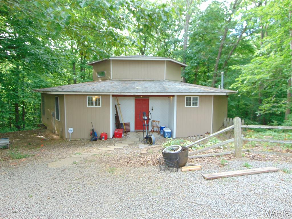 This is the property you have been waiting on! Enjoy the unique cabin with wood burner, covered porch and patio on approximately 13 acres with 2 large pole buildings and plenty of wildlife. This property is easily accessible and close to Kinkaid and the river while it is just minutes from town. There is plenty of storage in the buildings and the driveway is gated for your privacy. Call for your showing today.