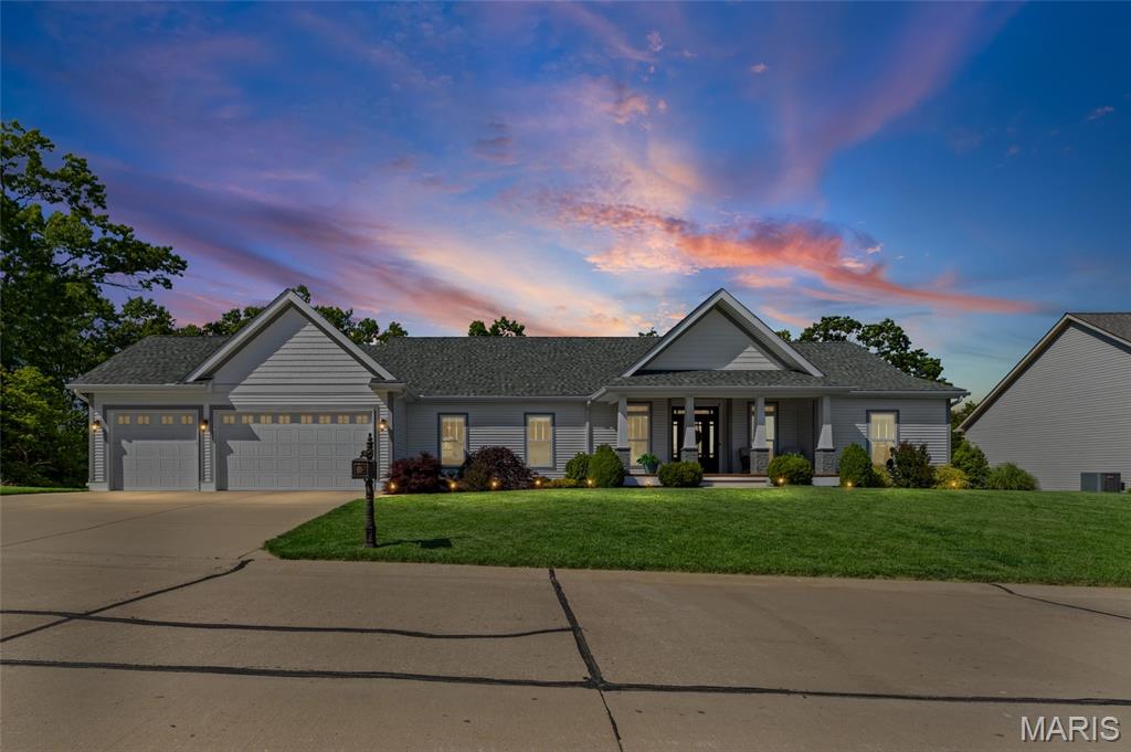 Tucked away in a picturesque setting, this Barnhart beauty is sure to impress. Offering over 3,300 square feet of thoughtfully designed living space, it seamlessly blends modern comfort with elevated style. From the inviting front porch to the high-end finishes throughout, every detail exudes warmth and sophistication. The covered front porch welcomes you and as you step inside the soaring coffered ceilings & a wall of windows create a striking first impression. The formal living room is complete with built ins, fireplace & luxury flooring as the open floorplan flows seamlessly to the kitchen. The kitchen is truly the heart of the home, an absolute showstopper! A massive center island, huge pantry and direct access to the deck overlooking serene wooded views make this space as functional as it is stunning. The lower level offers a more relaxed retreat (ideal for movie nights) with a walkout to the private backyard. 
With five generously sized bedrooms (four of which feature their own private en-suite bathrooms) this home offers exceptional comfort and convenience. The fifth bedroom, currently styled as a formal dining room just off the main living area, provides flexibility to suit your lifestyle, whether as a dining room, home office or guest suite.  The primary suite is a true sanctuary, complete with a spa-inspired bath, oversized walk-in closet, and luxurious soaking tub designed for relaxation. Looking for even more potential? The unfinished basement, currently used for storage, offers a blank canvas for additional living space, a home gym, or a custom entertainment area.
You will also love the huge main floor laundry room and mud room area with plenty of space to attend to your favorite chore (or the ability shut the door and hide it ;) 
Tucked in a private neighborhood.. All of this is set against a backdrop that simply can’t be beat.. offering privacy, beauty, and a place you’ll be proud to call home.