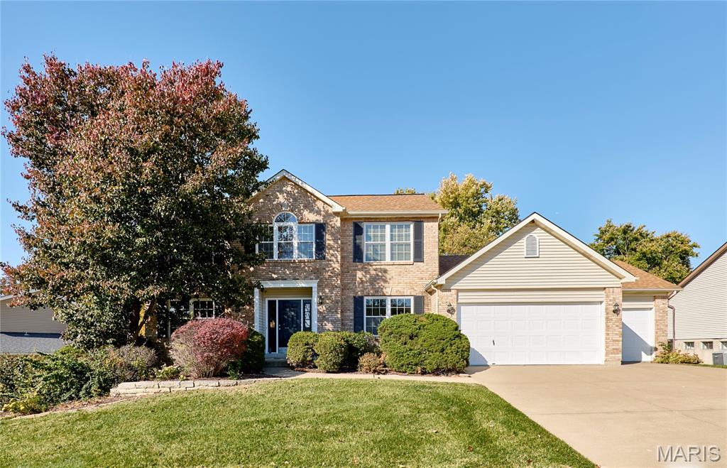 Welcome to this spacious & charming home in Canvas Cove offering over 3,200 sqft of living space with an ideal blend of space, comfort, and convenience with a finished walkout lower level and an oversized 3-car garage. The main level boasts hardwood floors in the foyer, great room, kitchen, and breakfast room, complemented by new carpet in the living and dining areas. Formal living and dining rooms provide flexible entertaining space, while the great room showcases abundant natural light and a cozy wood burning fireplace. The kitchen is designed for function and style with 42” cabinets, granite counters, peninsula, pantry & planning deck all just steps way from a generous main floor laundry. The breakfast room opens to a covered veranda with ceiling fans, perfect for morning coffee, entertaining or winding down a long day. Upstairs, a loft leads to the private primary suite with a walk-in closet, dual vanities, soaking tub, separate shower, and private water closet. Three additional spacious bedrooms and full hall bath. The finished walkout lower level includes a versatile rec room and a 3-season sunroom that open to a patio and mature trees & landscaping. A rough-in for a future bath provides expansion potential. Enjoy the large backyard with irrigation system, partial fencing, mature gardens, and shade trees. Conveniently located near Highways 364/64/K, shopping, dining, desirable Fort Zumwalt school district. This lovely home is ready for its next chapter!