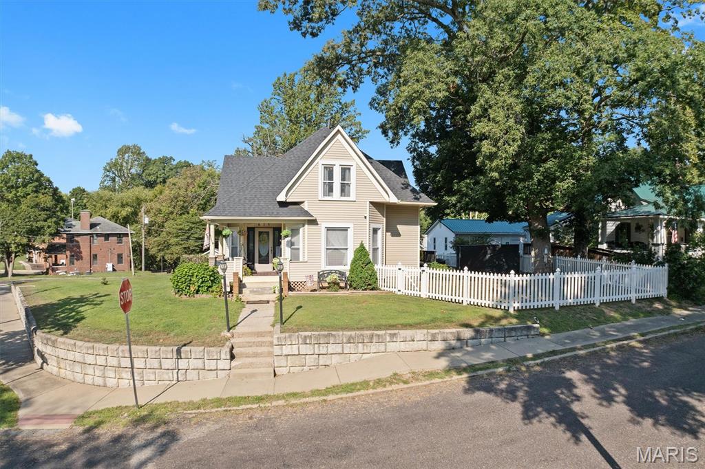 Character, charm, and beautiful original woodwork welcome you to this historic home, ideally situated on a corner lot near Greenville University. Relax on the covered front porch or enjoy the rear deck overlooking the partially fenced yard. Inside, the main floor features a beautiful eat-in kitchen with stunning oak cabinetry and stainless steel appliances, a generously sized dining room, a spacious living room with bay windows, plus a convenient bedroom and full bath. Follow the gorgeous wood staircase upstairs, where you’ll find three additional generously sized bedrooms and a second full bath. A carport provides convenient covered parking. A full, unfinished basement allows for plenty of additional storage. This inviting home blends timeless character with comfortable, functional living space. New roof 2024. Schedule a tour with your preferred agent!