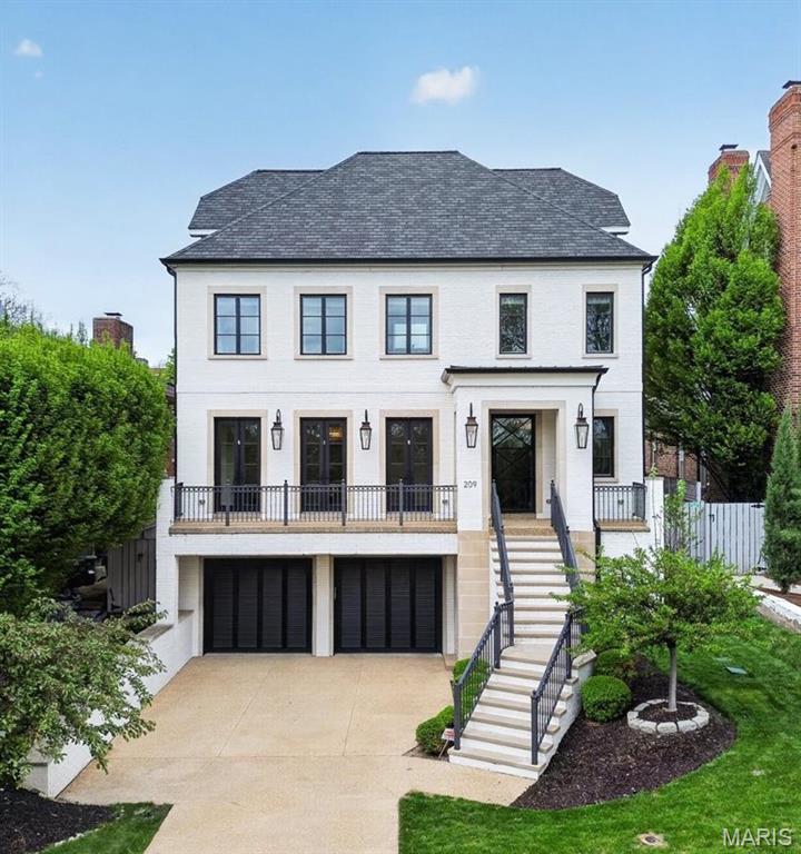 Chic, sophisticated living in the heart of Old Town Clayton—designed for those who expect the exceptional.  Spanning four finished levels with a private three-stop elevator, this residence showcases 10’ ceilings, rich hardwood floors, bespoke millwork, and designer finishes throughout. The main level is an entertainer’s dream, featuring a formal living room with gas fireplace and French doors to a sweeping terrace with gas sconces, a stunning dining room with a custom glass wine wall, and a chef’s kitchen/great room with an oversized center island, designer appliances, and a gas fireplace.  Upstairs, the spa-inspired primary suite is a true retreat, complemented by three additional en-suite bedrooms and a laundry room. The third-floor flex space with a full bath and bar offers breathtaking, unobstructed views of the Downtown Clayton skyline.  The ground level includes an oversized 2-car garage, mudroom, expansive rec room with bar, guest suite, and a private wellness space with a sauna.  Outdoor living rivals a luxury resort, with a covered patio featuring a gas fireplace and built-in grill, a pool with an automatic cover, and a beautifully turfed, low-maintenance yard. All just steps from the best of Downtown Clayton.  Fit for a King, this is elevated living at its finest. Prepare to fall in love.