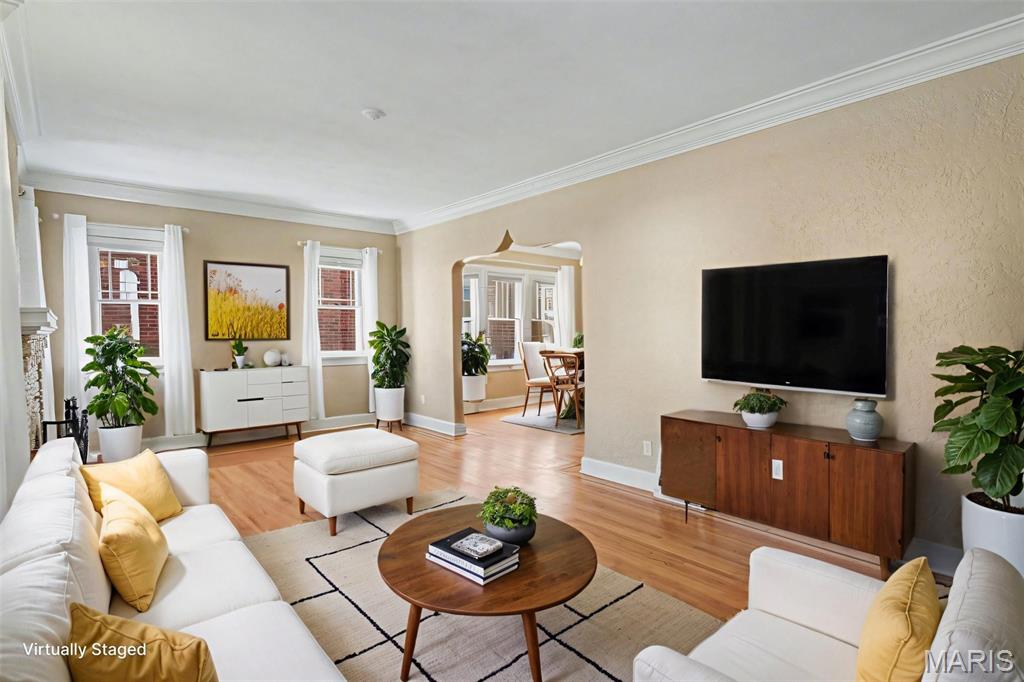 Welcome to this inviting 3-bedroom bungalow in highly sought after Signal Hill School District. This meticulously well cared for home offers timeless character, flexible living spaces, and room to grow. The main level of the home features two bedrooms, a full bathroom, and a versatile bonus office—ideal for working from home, a hobby room, or additional flex space.

The living and dining areas showcase storybook arched openings, ornamental crown molding, textured walls, and original refinished oak hardwood floors with classic picture-frame borders and contrasting inlay. A charming brick wood-burning fireplace with decorative hearth anchors the living room, while abundant natural light highlights the home’s period architectural details throughout.

Upstairs you'll find an oversized third bedroom with two closets that can easily double as a recreation room, craft room, home office, or theater room—offering endless possibilities.

The full unfinished walk out basement offers ample storage and future potential. Washer, dryer, and refrigerator are included for added convenience.

Enjoy morning coffee or evening conversations on the welcoming front porch, plus the convenience of a detached two car garage. Ideally located near shopping, dining, and everyday amenities, this well-cared-for bungalow blends historic charm with functional living—ready to welcome you home.

Select photos virtually staged to help visualize the space.