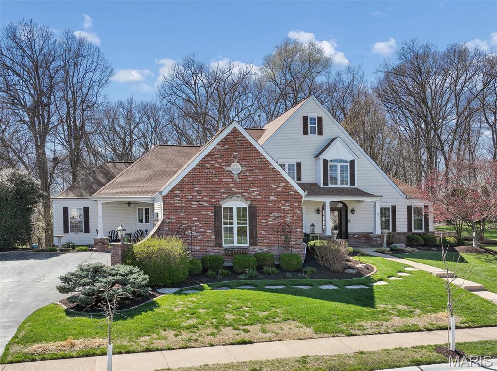 Welcome home to this Flower-built residence that effortlessly blends timeless design with everyday comfort. This beautifully crafted 1.5-story home captivates from the moment you arrive, with striking curb appeal, classic brick accents, and inviting front and side porches that set the tone for what lies within. Step through the front door into a light-filled foyer and discover a space designed to both impress and welcome. Rich wood flooring flows throughout the main level, leading into a breathtaking two-story great room anchored by a wall of windows that fills the home with natural light. Thoughtful details - plantation shutters, custom wood valances with roller shades, and built-in sound - create an atmosphere that is both refined and effortlessly livable. At the heart of the home, the chef’s kitchen inspires with quartz countertops, a spacious island with a 5-burner cooktop, double ovens, a walk-in pantry, and updated lighting - perfect for everything from quiet mornings to lively gatherings. Just off the kitchen, a warm and inviting hearth room offers the perfect place to relax, unwind, or gather - adding an extra layer of comfort and charm to the home’s central living space. The main-level primary suite offers a private retreat with a coffered ceiling and a beautifully updated, spa-like bath. Two additional bedrooms are tucked away and connected by an updated Jack-and-Jill bath, offering both comfort and functionality. A main-level laundry room adds everyday convenience. Step outside to a low-maintenance composite deck with a dry-below system and built-in gas line - ideal for effortless outdoor entertaining. The walk-out lower level, complete with zoned heating and cooling, provides endless possibilities for additional living or recreation space. Freshly painted and enhanced with an irrigation system, dual gas fireplaces, and a thoughtful collection of upgrades, this home is more than a place to live - it’s a place to truly feel at home. Make it your haven today.