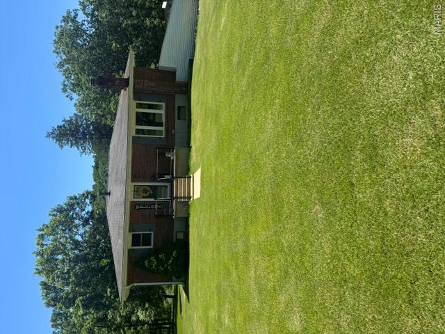 Looking for that wonderful spot in the country. Located minutes away from river. This three bedroom and 2 bath home has had extensive remodeling done in the last few year. Country kitchen with new  cabinets, sink, back splash, stove, refrigerator and microwave. New windows through out the home except 2. New central heat and air in 2025. All new flooring. Bathrooms remodeled. Living room is open with wood beams.  Living room  also has wood stove with brick surround. Large storage area with shelves for pantry items. Fenced in pasture for horses. New well house.
