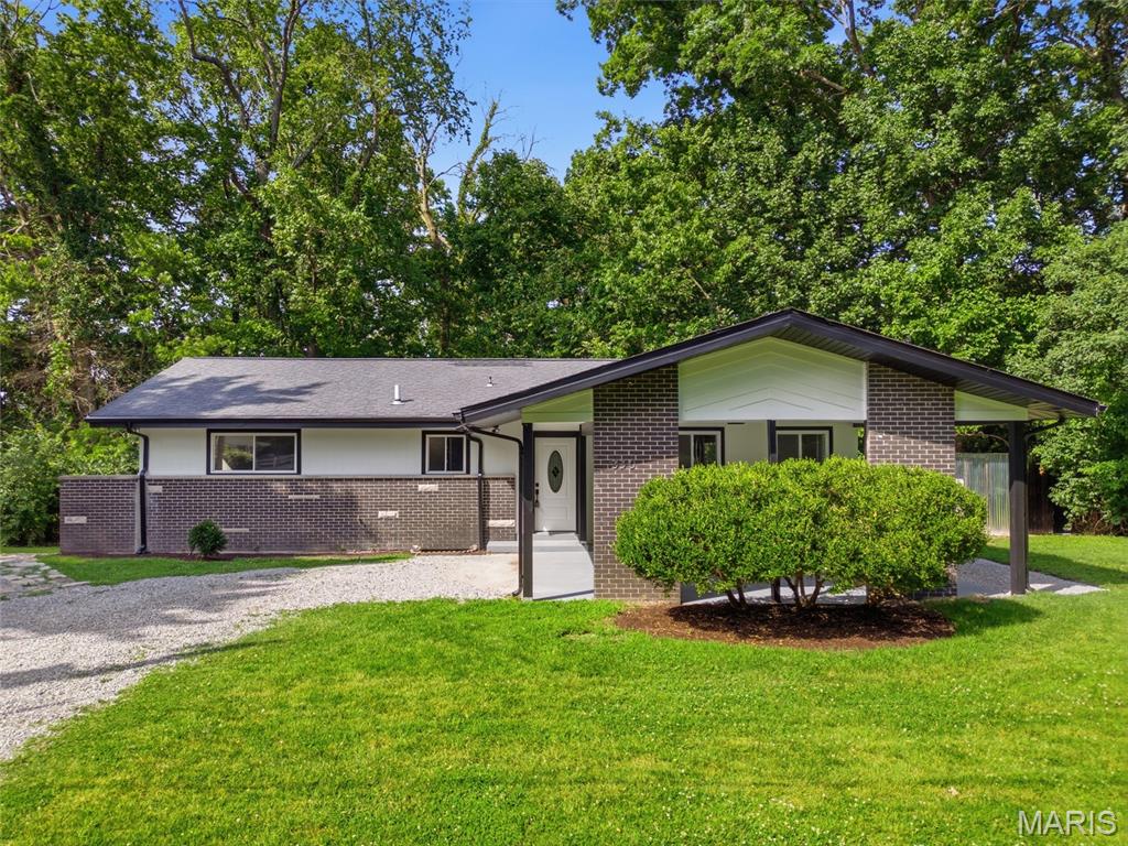Due to strong interest and showing activity, Seller is requesting all offers to be submitted by Monday 08/10 at 8:00 PM. Welcome to this spacious 4-bedroom, 2-bath home situated on a secluded, partially wooded 0.70-acre lot, offering privacy while remaining just minutes from schools, shopping, and major Metro East thoroughfares. The main level features soaring vaulted ceilings, abundant natural light from new windows, and a spacious living room. The eat-in kitchen has been beautifully remodeled with new cabinetry, quartz countertops, and stainless steel appliances, and flows seamlessly into the living area. The main level also includes the primary bedroom, two additional bedrooms, and a fully remodeled full bathroom. The partially finished walk-out basement expands the living space with a fourth bedroom, a second fully remodeled full bathroom, and direct access to the peaceful backyard. Enjoy the wooded setting from either of the two decks, perfect for relaxing or entertaining. Recent improvements include a new HVAC system, updated electrical and plumbing, replacement windows, and updated ceiling fans. Offering approximately 1,300 square feet on the main level plus the finished lower level, this home combines privacy, space, and modern updates in a convenient location.