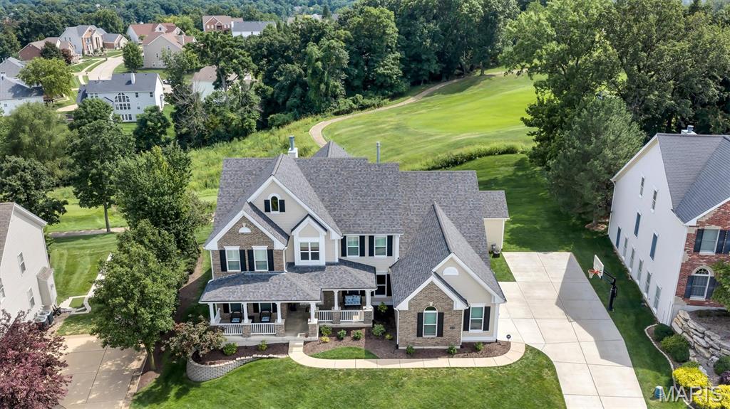 Set on a half-acre and backing to a fairway on Tapawingo National Golf Club, this five bedroom, four and a half bath home offers 6,127 square feet of finished living - 4,225 above grade plus a 1,902 square foot walk-out lower level. A two-story foyer opens to a great room with a wall of windows crowned by an arched Palladian, framing the golf course beside a gas fireplace. You will also find a formal dining room with crown molding and office when you enter the home.  

The updated kitchen delivers a granite island, six-burner JennAir gas range with chimney hood, JennAir built-in refrigerator, wall oven with warming drawer, walk-in pantry, and butler's pantry with beverage refrigerator. The vaulted hearth room and breakfast area open to a composite deck overlooking the course.

The main-floor primary suite features double-door entry, dual walk-in closets, and a vaulted bath with double vanity, separate shower, and soaking tub. Upstairs: a loft, a private ensuite bedroom, and two bedrooms sharing a bath.

The finished walk-out lower level is an entertainer's dream — recreation room, second full kitchen, theater with projector and surround sound, fitness room, fifth bedroom, and full bath opening to a resort-like yard.

Fresh paint and new carpet throughout (July 2026), roof and 6" gutters (2026), Hardie siding (2026), windows (2023), main-floor laundry, and an oversized three-car side entry garage. Lindbergh Schools and minutes to I-270/I-44.