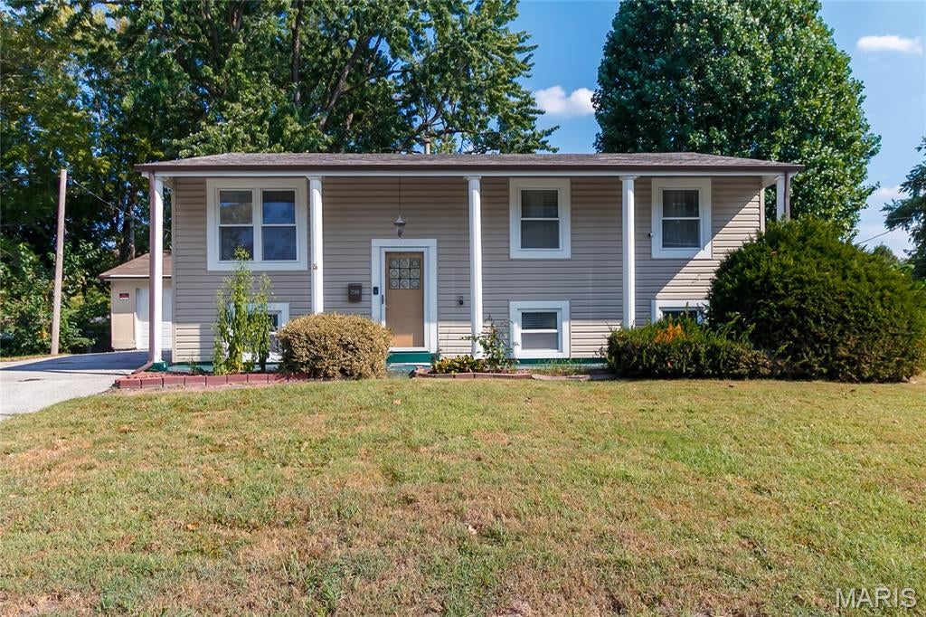 Welcome home to this inviting split-level, tucked away in a quiet neighborhood and offering plenty of space both inside and out. Hardwood flooring runs throughout much of the home, complemented by ceramic tile in the updated bathrooms and kitchen. The kitchen offers ample cabinet space and opens to the breakfast/dining area, where a sliding glass door leads to a spacious wooden deck—perfect for summer barbecues, relaxing, and outdoor entertaining.

The walkout lower level provides additional living space with a large family room and third bedroom, previously used as a home office. Step outside to the fenced backyard, offering plenty of room to enjoy the outdoors. An oversized two-car detached garage provides additional storage and convenient access to the backyard.

Recent improvements include updated tile and safety rails in the upper-level bathroom, a new steel entry door on the garage (2026), a new sliding door leading to the deck, and a newer roof with a transferable warranty. Siding and gutters were replaced in 2022. 

Move-in ready with several major updates already completed, this home is ready for its next owner. Property is being sold As-Is.