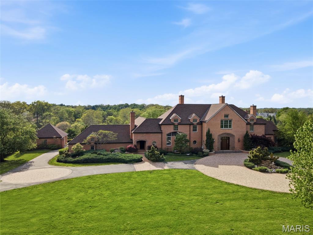 Set on a private gated lane in prestigious Huntleigh, 17 Bridle Ridge Lane is an extraordinary estate that embodies refined luxury, architectural elegance, and uncompromising privacy. Gracefully positioned on four lush, meticulously landscaped acres, this magnificent residence offers an unparalleled blend of grand-scale living and intimate comfort. Boasting 5 grand bedrooms, 6 full bathrooms, and 5 impeccably appointed half baths, the home is thoughtfully designed with exquisite craftsmanship and bespoke finishes throughout. A dramatic entry foyer introduces its sophisticated living spaces, ideal for both large scale entertaining and intimate gatherings. The culinary inspired kitchen is a masterpiece of design and function, featuring premium appliances, custom cabinetry, and an expansive island that anchors the heart of the home. Adjacent formal and informal living areas are adorned with rich materials, designer lighting, and walls of windows that frame serene views of the estate grounds. Retreat to the luxurious primary suite, a private sanctuary complete with a resort style bath, expansive dressing area, and unrivaled closet space which includes space for a washer and dryer.  Each additional bedroom suite offers exceptional comfort and privacy for family and guests alike.
Designed for elevated living, the estate features a state-of-the-art fitness center, a resort-style pool with surrounding terraces, and multiple indoor-outdoor spaces curated for relaxation and entertaining. Car enthusiasts will appreciate the impressive 5-car garage, while the gated approach ensures the utmost in exclusivity and security. 17 Bridle Ridge Lane is more than a home—it is a statement of timeless sophistication and distinguished living in one of Huntleigh’s most coveted enclaves.