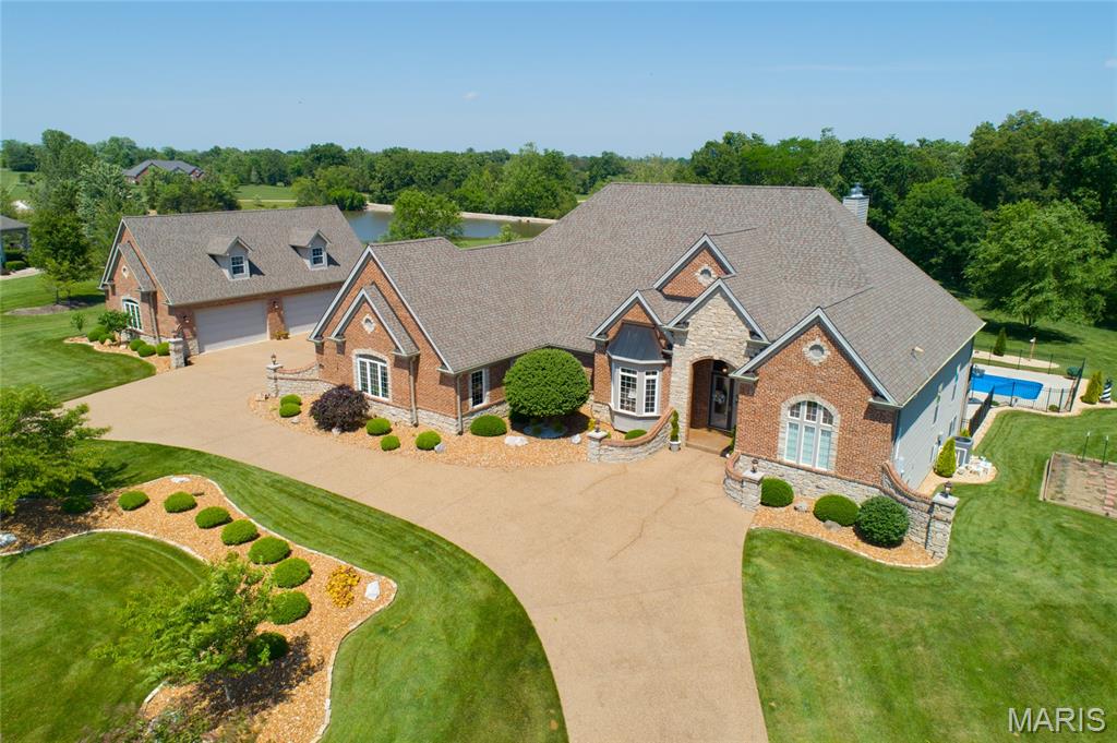 Stunning Executive Style Ranch Home with over 7400 sq ft of Living Space, 5 Beds/5 Updated Bath, 2 Fireplaces, 2 Kitchens, Full Finished Lower Level, 6+ Car Garage with Finished Loft, the Perfect Outdoor Living Space with a Large Pool, Hot Tub, Composite Deck and Much More! You will be Instantly Impressed as you pull up to this home with 4.5 Acres of Beautifully Manicured Grounds. The Circular Aggregate Driveway leading to your Custom Built Home! Welcome Friends into the Large Foyer with 12 Ft Ceiling, Columns, Wood Flooring, Open Floor Plan and Lots of Natural Light! The Main Floor Gourmet Kitchen is Unmatched with Custom Cabinets, Granite, Large Center Island, Walk-in Pantry, Breakfast Room along with the Hearth Rm! This is a Split Ranch so the Master Suite is Large with a sitting rm, 2 Primary Closet & Luxury Bath with Separate Tub/Shower and Adult Height Vanities. The other 2 Bedrooms are also Generously Sized! The Finished Walkout Basement is Spectacular with Rec Rm, Full Kitchen, Custom Bar, 2 additional Bedrooms and 2 bath, don't miss the Current Craft Room/Gym Area! Walkout the French Doors to your Resort Style Large Patio & Pool Area for Large Parties or Just Family, Perfect! The Separate 4 Car Garage is oversized with a Finished Loft for Man Cave or additional Storage! Notice the extensive Private Lot! This is a MUST SEE Opportunity, Don't Miss this Home!