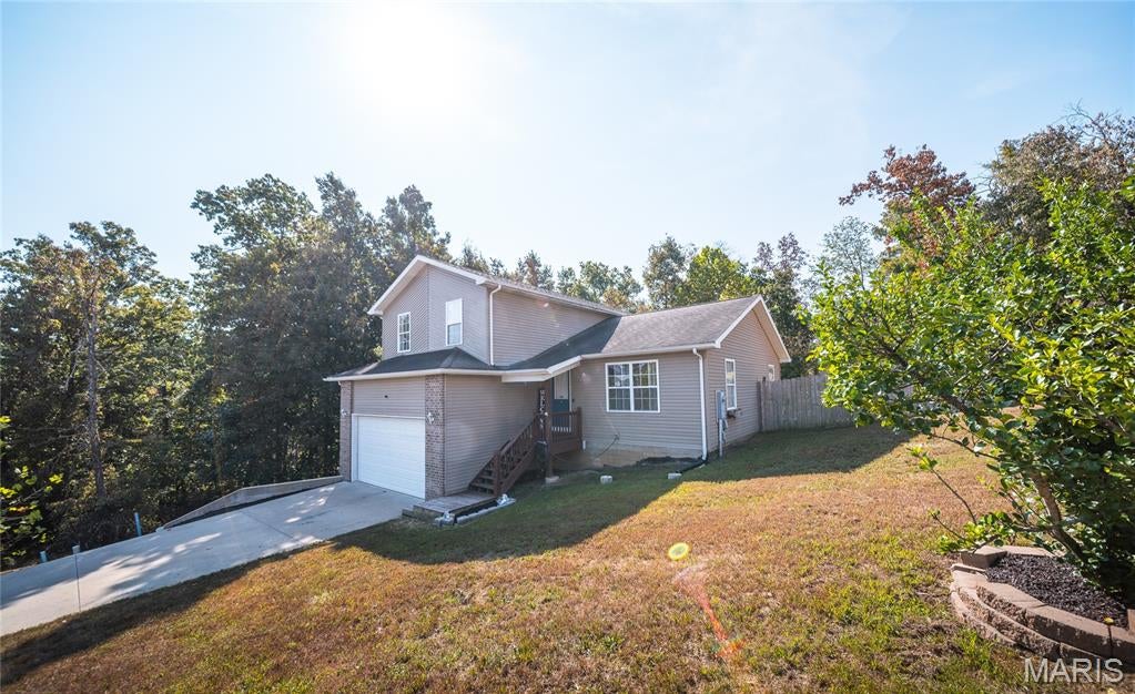 Welcome to this beautiful multi-level home tucked away at the end of a quiet street in St. Robert! Offering 3 bedrooms and 2.5 bathrooms, this thoughtfully designed home combines comfortable living spaces with plenty of room to relax and entertain. The main level welcomes you with a bright, open floor plan featuring a sunlit living room, beautiful kitchen, and dining area. The kitchen boasts a large center island with abundant counter space, while the dining area provides walkout access to the first of two back decks. Upstairs, you'll find all three bedrooms, including a spacious primary suite complete with a double vanity and enormous walk-in closet. Two additional bedrooms offer great natural light and ample closet space, along with a second full bathroom. The lower level provides even more living space with a family room, wet bar, and walkout access to the second back deck. A convenient laundry area with custom cabinetry and storage connects to the third full bathroom, with garage access also located on this level. Outside, enjoy a fully fenced backyard with two decks offering multiple spaces for relaxing, entertaining, or simply enjoying your privacy. Tucked away in a peaceful setting yet just 10 minutes from the Fort Leonard Wood gate, this home offers the perfect combination of comfort, privacy, and convenience. Call today to schedule your private showing!