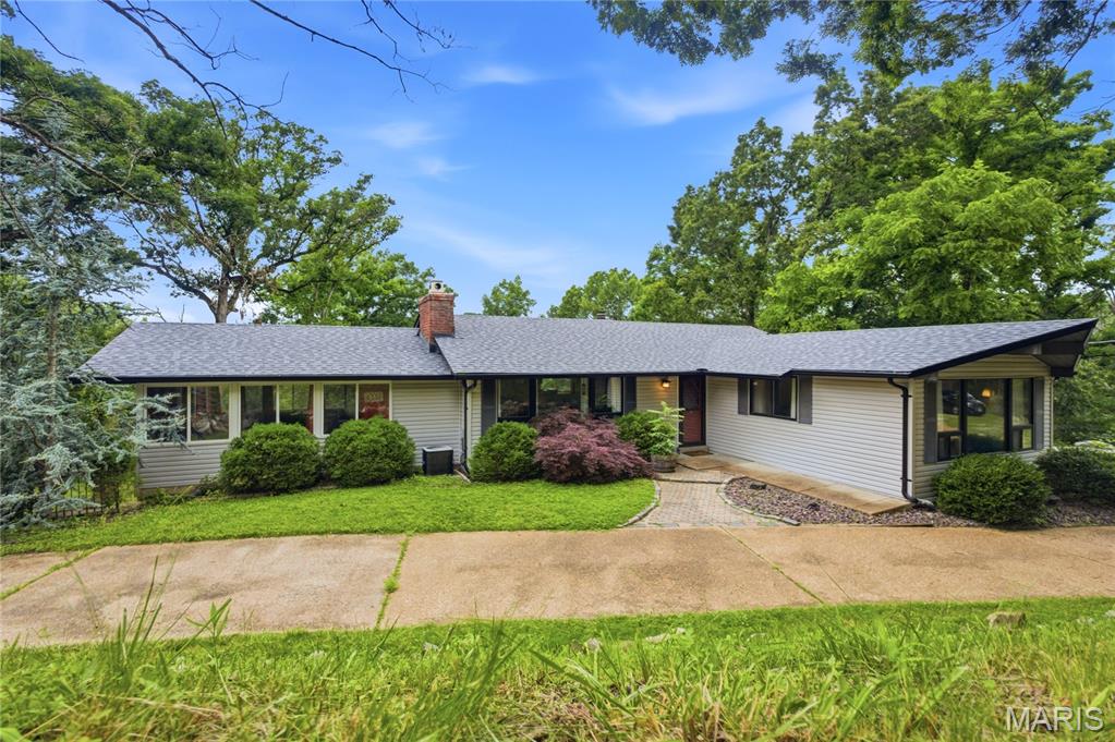 Discover the rare opportunity to own more than 4 wooded acres in the heart of Wildwood. Nestled on a private 4.26-acre lot, this charming ranch offers the perfect blend of peaceful country living and convenient access to shopping, dining, parks, and top-rated Rockwood schools.

Inside, you'll find 3 bedrooms, 2.5 baths, and a warm, inviting floorplan designed for everyday living. Hardwood flooring flows through much of the main level, while the spacious living room features a wood-burning fireplace that creates a cozy focal point. The dining area and family spaces provide flexibility for gatherings, entertaining, or simply enjoying the tranquil surroundings.

The walk-out lower level offers additional finished living space, a half bath, and room for recreation, hobbies, a home office, or future expansion. Large windows throughout the home showcase beautiful wooded views and bring the outdoors in.

Whether you're enjoying your morning coffee while listening to the sounds of nature, exploring your own acreage, or entertaining family and friends, this property offers a lifestyle that is increasingly difficult to find in St. Louis County.

If you've been searching for privacy, usable acreage, a ranch floorplan, and a sought-after Wildwood location, this is a property you won't want to miss.