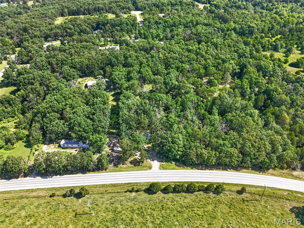 Opportunity awaits on this versatile 7.38-acre property with approximately 150 feet of excellent frontage on East Highway 32! The mostly level acreage offers endless potential for residential, commercial, investment, or hobby use. The centerpiece of the property is a well-maintained 30x60 shop featuring concrete floors, electric service, three garage doors (two front-facing and one side-entry), and plumbing in place for a bathroom that just needs to be finished. The shop is connected to the lagoon, is in great condition, and is currently being cleaned out, making it ready for its next owner. The property also includes two mobile homes, one of which is planned to be removed prior to closing, while the other provides valuable storage space. An additional bonus is the existing utility setup at both the shop and the front of the property, including electric and water, making it an ideal location for a new home, manufactured home, business, or future development. The acreage features established trails that can be driven throughout the property, allowing you to easily explore and enjoy the land. With usable acreage, excellent highway visibility, and multiple potential building sites, this property offers a rare combination of accessibility, flexibility, and opportunity. Whether you're looking to build, invest, start a business, or create your own homestead, this property is ready for your vision.