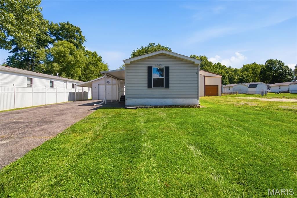Affordable homeownership just got a whole lot more appealing! This charming 2-bedroom, 2-bathroom home offers something that's becoming increasingly hard to find—ownership of both the home and the lot, with no monthly lot rent.
Freshly painted throughout and featuring updated laminate flooring in 2025, this move-in-ready home is packed w/ comfort and value. The functional layout offers comfortable living spaces, while recent updates, including a new furnace in 2022, provide added peace of mind.
Outside, you'll appreciate the storage and parking options, including a garage, carport, storage shed, and plenty of off-street parking. You will also love the yard space, not too big and not too small, yet plenty of green space for outside activities
Conveniently located just minutes from interstate access, shopping, restaurants, and everyday amenities, you'll enjoy the perfect combination of accessibility and convenience without sacrificing the feeling of home.
Whether you're looking to downsize, purchase your first home, or add to your investment portfolio, this well-maintained property is one you won't want to miss.