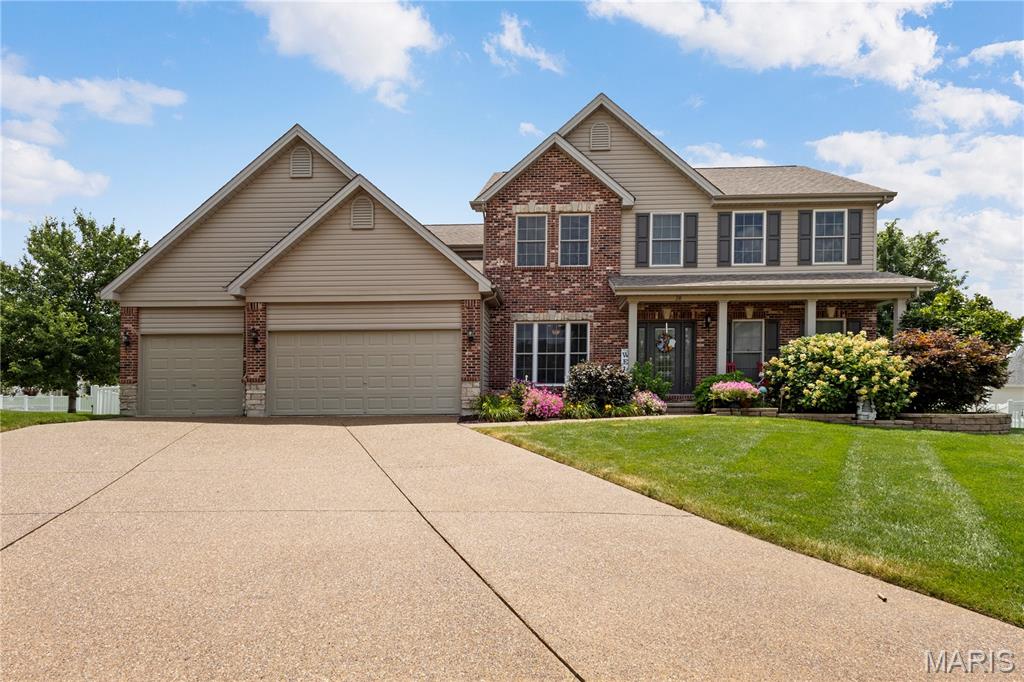 Welcome to this beautifully updated 1.5-story home nestled on a quiet cul-de-sac in desirable Avondale Heights! Offering nearly 4,500 square feet of finished living space, this versatile floor plan is designed for both everyday comfort and effortless entertaining. Step inside to a dramatic two-story Great Room featuring a stunning brick fireplace and a wall of windows that fills the space with natural light. The Great Room flows seamlessly into the kitchen and breakfast area, where you'll enjoy abundant custom wood cabinetry, granite countertops, a center island, under-cabinet lighting, a walk-in pantry, and stainless steel appliances, including a 3-door refrigerator, 5-burner gas range, newer microwave, and dishwasher. The adjacent dining room provides ample space for hosting family gatherings and dinner parties. The spacious main-level primary suite is a private retreat, complete with a charming bay window, ceiling fan, an oversized walk-in closet with custom built-ins, and a luxurious ensuite bath featuring dual vanities, a soaking tub, and a separate shower. Upstairs, you'll find a vaulted loft overlooking the Great Room, along with three generously sized bedrooms, each with walk-in closets, and a full hall bath. The finished lower level expands your living space with a kitchenette, a large recreation room ideal for movie nights or game days, a full bath, and two additional flex rooms perfect for a home office, music studio, exercise room, or hobby space. Technology enthusiasts will appreciate surround sound in the Great Room, primary bedroom, loft, lower level, garage, and patio, along with more than a mile of Ethernet and coaxial cabling installed throughout the home. Outdoor living is just as impressive, featuring a 20' x 16' covered patio, a gas fire pit with an interior on/off switch, and plenty of space for a future hot tub or outdoor kitchen. The fully fenced backyard also includes a separate fenced area that's perfect for pets. Additional highlights include a glass front entry door, hardwood floors, newer carpet in select areas, dual HVAC systems, main-floor laundry, a drywalled 3-car garage, an 8-zone irrigation system, low-maintenance vinyl and brick exterior with attractive stone accents, and a recently sealed aggregate driveway. This exceptional home truly has it all!