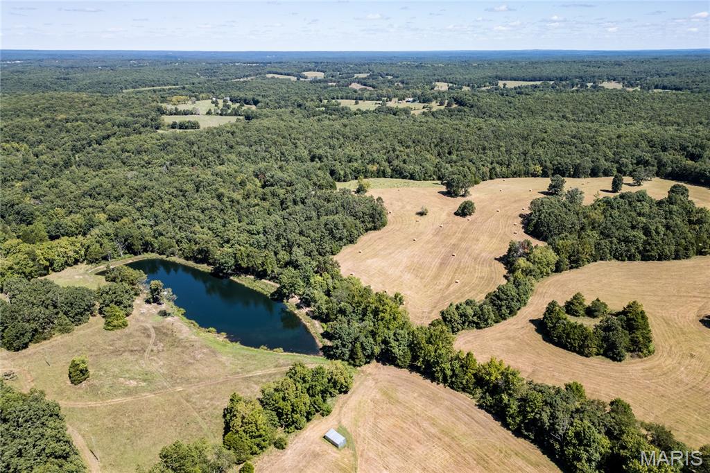 Timber, pasture, privacy, hunting, fishing, weekender, deer camp, full-time -- only 90 minutes from St. Louis --  Lazy H Ranch offers it all. A rar opportunity to own 132 private acres in Crawford County, Missouri, just three miles south of Steelville, MO. This exceptional recreational property, hunting property, and private country retreat offers the perfect mix of mature timber, open pasture, established trails, and abundant wildlife, including excellent deer hunting and outdoor recreation.

Water is a major highlight, featuring a stocked 2.5-acre lake with dock, ideal for fishing, swimming, kayaking, or launching a small boat. Two additional ponds and seasonal creeks add natural beauty, wildlife habitat, and everyday function to the land.

A private drive leads into the property, creating true seclusion and privacy while still offering convenient access to Steelville, local services, and nearby outdoor destinations. The home is a 3-bedroom, 2-bath, 1.5-story barndominium with an open-concept floor plan designed for comfortable country living. An oversized garage provides excellent space for equipment, recreational vehicles, ATVs, UTVs, boats, tools, storage, or workshop use.

The deep front porch runs the length of the home and offers peaceful views of the surrounding land — the kind of porch built for coffee, sunsets, wildlife watching, and quiet Missouri mornings.

Located close to town while feeling worlds away, Lazy H Ranch offers a rare combination of Missouri acreage, private land, water features, hunting, pasture, timber, trails, and residential improvements. Properties with this much usable acreage, water, privacy, and improvements this close to Steelville are increasingly hard to find.  See link for drone tour aroundlazyhranch.com

Shown by appointment only. Duplicate Listing #26004423.12-0-00-007.010;15-3.0-07-0-00-003.000