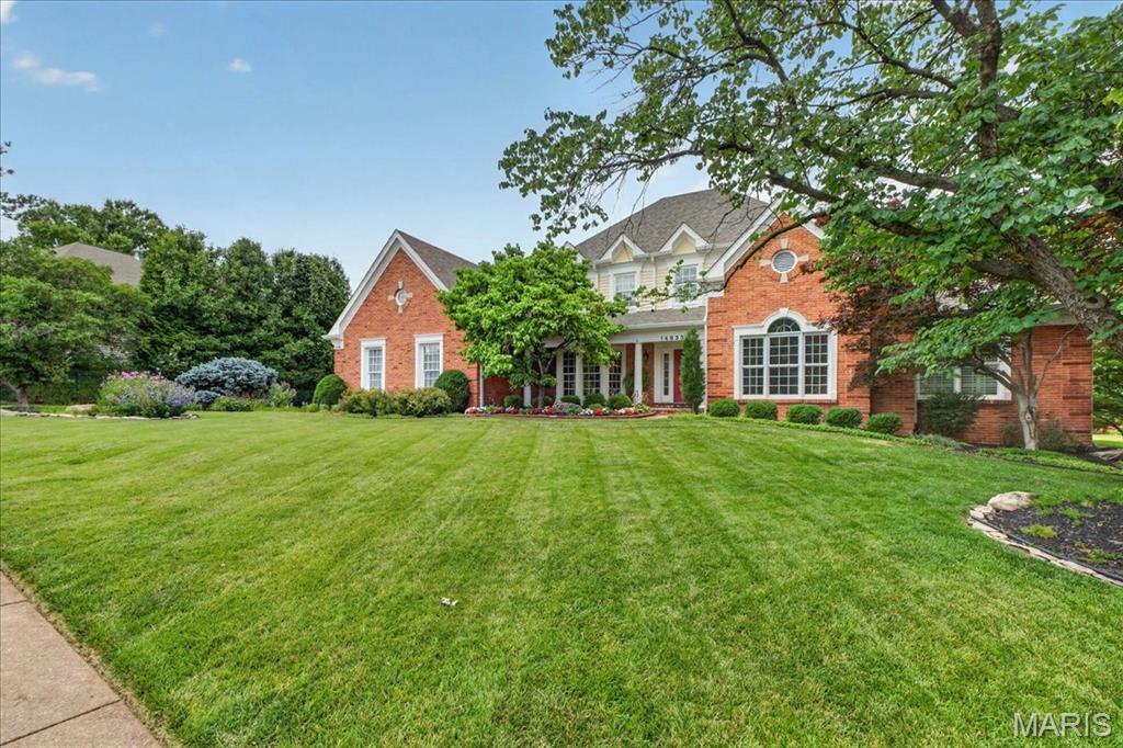 Gracious, elegant executive 1.5 story situated on beautiful corner lot with extensive landscaping! Dramatic 2-story entry. Gourmet kitchen with custom-designed center island, expanded main floor laundry with cabinetry, wet sink with access to garage or to deck, the formal dining room, paneled library/den with built-in bookshelves, family room with fireplace, built-in bookcases, & wet bar. Wonderful sunroom with vaulted ceiling and skylights. The master bedroom suite includes coffered ceiling, two walk-in closets, and spacious gorgeous remodeled primary bath accented with white cabinetry, soaking tub plus a walk-in shower, detail to design was factored in allowing the area to be handicap accessible for the commode. The upper level offers three additional bedrooms with two full bathrooms,
Knockout, professionally finished walkout lower level includes second fireplace, beautiful custom wood wet bar, 9' ceilings, two additional bedrooms, full bath and two large recreation areas! 
This outstanding home includes numerous upgrades  such as composite deck overlooking manicured backyard, brand new roof going on soon, gutters 2023, HWH 2022, richly appointed with extensive millwork makes this truly an executive level home with crown molding, arched door openings, gleaming wood floors in foyer, family room, kitchen/breakfast rooms and laundry, three-car garage with epoxy floor, irrigation & security systems, concrete driveway, and central vac. Parkway West Schools.