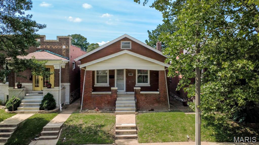 Welcome to 5218 Lisette Avenue—a charming South St. Louis home full of character, style, and functionality! This inviting 2-bedroom, 1-bath home features beautiful hardwood flooring throughout much of the main level, along with stunning stained-glass windows in select areas, adding timeless character and architectural charm. The spacious living room is filled with natural light and showcases a decorative fireplace, creating a cozy focal point for relaxing or entertaining. A separate dining room offers the perfect space for family dinners or hosting guests. The updated kitchen is truly a standout, featuring beautiful 42-inch cabinetry, solid surface countertops, and a stylish tile backsplash—blending beauty with everyday practicality. Both bedrooms are generously sized and continue the hardwood flooring, while the full hall bath is conveniently located on the main level. A versatile bonus room off the back of the home provides endless possibilities—ideal for a home office, family room, sunroom, or flex space to fit your needs. Downstairs, the walk-out lower level offers abundant storage space and easy access to the backyard patio. Step outside to enjoy the fenced backyard, perfect for entertaining, pets, gardening, or simply relaxing outdoors. Nestled in a desirable neighborhood close to parks, shopping, dining, and everyday conveniences, this home offers the perfect blend of classic charm and modern updates. Don’t miss your chance to make it yours!