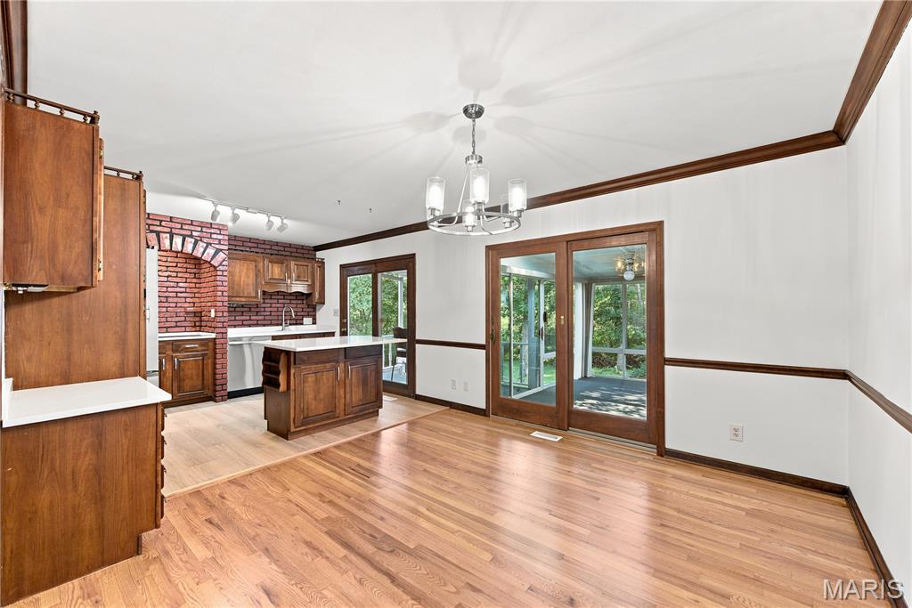 NEW PRICE! You have to come and see this lovely split level home located on almost a half acre. Lots of trees in the back of of the yard for shade and privacy and plenty of grass area for outdoor activities. If you've been wanting to be in the Parkway West school area, this is your chance to own a great home that is ready for you to add your finishing touches on it. This move in ready 4 bedroom 2 bath split level home features on the main floor a large living room with gas fireplace, new vinyl windows on the front of the house, and hardwood floors that flow into the kitchen/dining room combo. Wood-stained chair rails all around the room and with wood-stained crown molding throughout the main floor rooms as well. Pella wood slider door leads out to the enclosed sunroom/porch perfect for extra living space while enjoying your private view of nature. Three bedrooms are on the main floor and share the full bathroom with tub/shower combo and extra linen closet. Kitchen has all new stainless-steel appliances and a cool retro/mid century modern look to it. Plenty of cabinetry for storage needs. Head down to the lower level and you’ll find a huge multi-purpose room with gas fireplace perfect for additional living. This could be the 4th bedroom, rec room, workout space, game room, so many options. Full bathroom is also on this level. Freshly painted, new vinyl siding July 2026, AC is approximately 1 year old, roof approximately 8 years old. Washer and dryer stay with the home. Come and bring your imagination and see yourself living at 205 Morewood Dr.