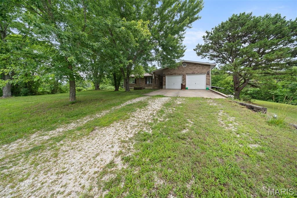 Escape to the peace and privacy of country living with this charming 3-bedroom, 2-bathroom home situated on 12.64 acres m/l in Newburg, offering convenient nearby interstate access for an easy commute. Inside, you'll find a comfortable layout featuring a spacious living room, a separate dining room with access to the covered back patio, a functional kitchen, and a primary suite with a private ensuite bathroom. The home also includes a centrally located laundry room and a large hall closet for added storage. A partial basement offers additional space and includes a possible 4th bedroom, making it ideal for guests, a home office, or hobby space. Outside, the property is well-equipped for country living with a 28x40 workshop, large chicken coop, and plenty of room to enjoy the outdoors. Major updates provide peace of mind, including a new roof with a transferable warranty, new furnace, and new AC unit—all completed in 2025. Don't miss this opportunity to own a versatile acreage property with modern updates and room to grow. Schedule your private showing today!