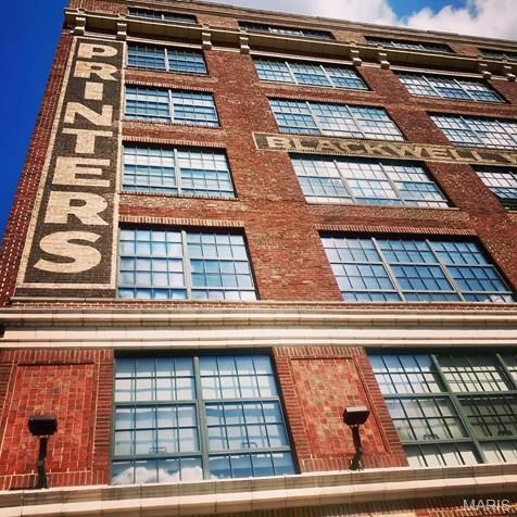 Rare top-floor loft in Historic Printers Lofts, priced below market and ready for its next chapter. Offered as-is, this is a standout opportunity for a buyer with vision to enhance an already impressive space.

The essentials are here: soaring ceilings, exposed concrete columns, a full wall of operable warehouse windows, exposed brick, and the unmistakable industrial character that makes Printers Lofts so desirable. The spacious primary suite faces south, capturing bright morning light and sweeping skyline views, and includes a private en-suite bath. South-facing great room windows fill the main living area with warm afternoon light, creating a flexible space equally suited to quiet evenings or larger gatherings.

Printers Lofts is a two-building development, with both buildings listed on the National Register of Historic Places. The western building, formerly the Advertising/Mary Muffet building, dates to 1917; the eastern Blackwell-Wielandy building dates to 1907. Both originally housed prominent printing companies, book firms, and stationery businesses before being transformed into the loft community residents enjoy today.

Building amenities include a rooftop deck with grills and patio seating, unobstructed urban views, a fitness center, and two club rooms. One assigned garage parking space and storage space are included.

A rare chance to secure a top-floor loft at Printers Lofts at a compelling price point.