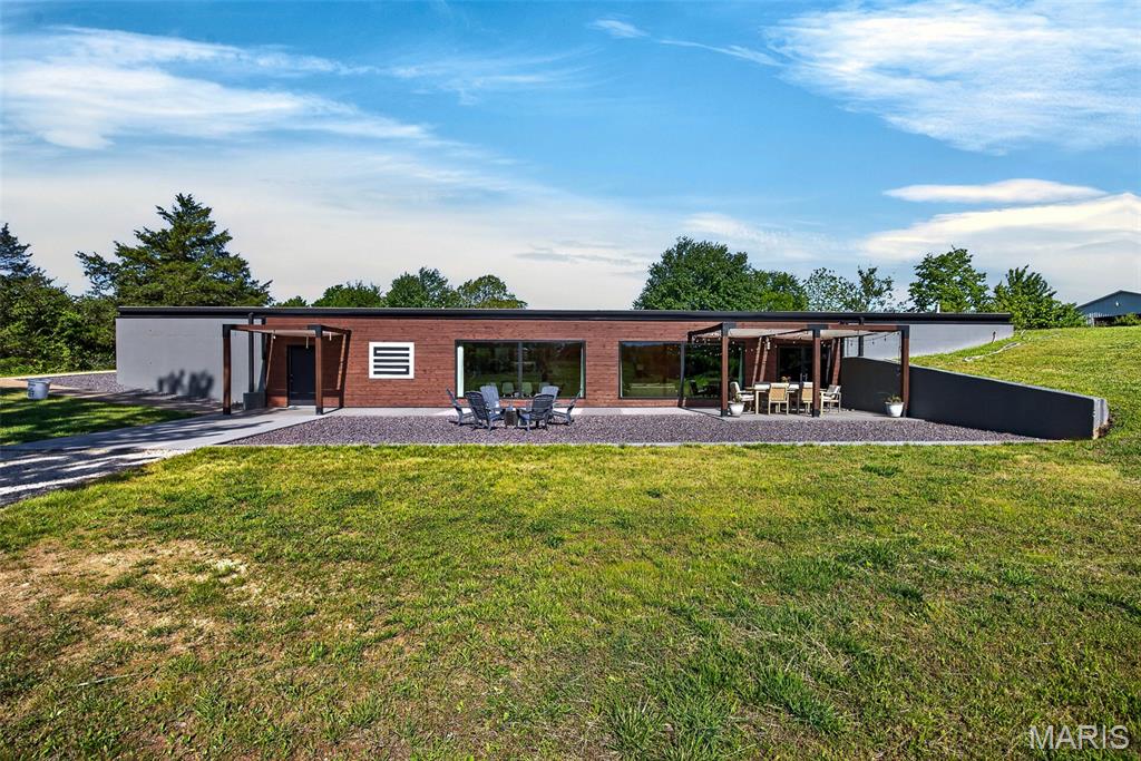 This one-of-a-kind commercial property offers the perfect blend of functionality, creativity, and opportunity! Situated on 5 picturesque acres in the county, this fully renovated 4,200 sq. ft. building was thoughtfully designed with versatility in mind — and with no city restrictions, the possibilities are truly endless. Boasting highway frontage with excellent visibility and high traffic exposure, this property offers outstanding potential for business growth, customer access, and brand recognition. Inside, you’ll find 7 private offices, a theater space, professional recording studio, custom bar area, full kitchen, and sound-resistant tiles throughout, creating an ideal setup for media production, entertainment, or professional business use. A massive 24x40 open studio provides a blank canvas ready to fit your vision, whether that’s additional workspace, event space, retail showroom, fitness studio, or worship area. Fiber internet is already in place, providing the speed and reliability today’s businesses demand for streaming, production, remote work, and daily operations. Recent improvements include a brand-new commercial grade roof, new electrical, and new plumbing- adding long-term value and peace of mind for future owners. Outside, the property continues to impress with a huge stocked pond and peaceful acreage offering privacy and a scenic setting for clients, employees, or guests. Whether you’re looking to establish a recording studio, retail business, dental or medical office, church, event venue, creative workspace, or multi-use commercial investment, this rare property is ready to bring your vision to life.