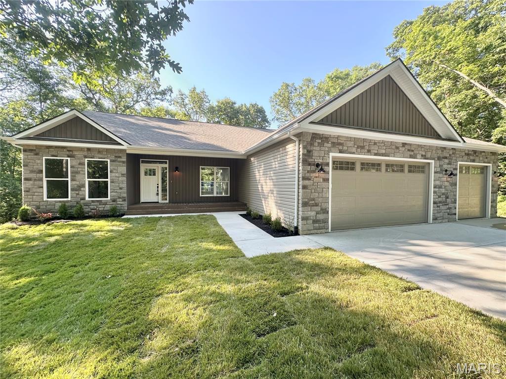 Beautiful-Private-Spacious.  Brand New Home with almost 3,000 sq ft of finished living space, nestled on 3 acres.  Tucked away at the end of a one road neighborhood on a cul de sac.  This 5 bedroom 3.5 bath home has so much to offer.  Open floor plan - Huge living room with 11 ft ceilings, views of the wooded back yard, and electric fireplace.  Separate dining room.  Kitchen features beautiful custom cabinets with quartz counters, 8' island, composite sink, stainless appliances and luxury vinyl plank flooring.  Huge walk in pantry with cabinets and quartz counters matching the kitchen.  Split bedroom floorplan - Primary bedroom with tray ceiling and view of the woods in the back yard.  Attached primary bath with double vanity and large walk in shower.  Bedrooms 2 and 3 share a jack and jill bath.  Main floor laundry and a powder room round out the main level.  Enjoy the privacy hanging out on the 11 x16 composite deck off the living room.   Walk out lower level with 9 ft foundation, Family/Rec room, 2 bedrooms - one with an attached full bath, and a ton of storage space.  The lot is pie shaped spreading out very wide in the back.  Community shared well (only $200/yr)  Septic so no sewer bill.