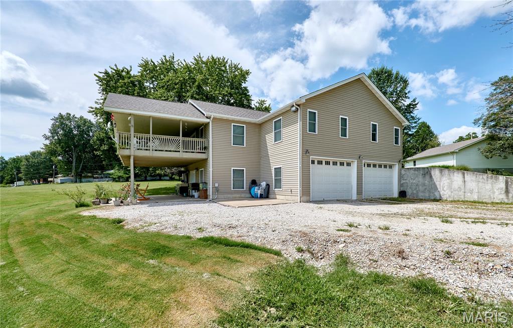 LAKEFRONT ACREAGE & ENDLESS POSSIBILITIES! Discover the rare opportunity to own approximately 25 acres featuring a spacious raised ranch home overlooking an approximately 7-acre private lake! This 3-bedroom, 3-full-bath home offers an expansive great room with a 30x16 covered deck providing the perfect setting to enjoy peaceful lake views, entertaining, or simply relaxing in your own private retreat.

The kitchen features a center island with gas cooktop and exhaust fan, built-in microwave, dishwasher, trash compactor and breakfast bar, plus a separate dining area with plenty of room for a large dining table and a French door to backyard. The main-level primary suite features a jetted tub, separate shower and dual vanities, while the two additional generously sized bedrooms share a convenient Jack-and-Jill bath.

Built with quality construction in mind, the lower level features 2x8 exterior walls, the upper level has 2x6 walls, modern floor joists and blown-in cellulose insulation. Thoughtful accessibility features include 36-inch doors throughout the main level.

But the possibilities extend well beyond the home! With approximately 25 acres, a private lake with great fishing, no HOA and no known restrictions, this property offers tremendous flexibility and potential for future development, additional homes, or recreational opportunities. An RV hookup with its own private septic system is already in place. Imagine exploring the possibility of additional RV campsites around the lake for potential income—or developing additional homesites. (Any future development, subdivision, additional RV sites or income-producing uses are subject to applicable zoning, permits, utilities, approvals and buyer due diligence.)

Public sewer is connected and public water is available, while the owner currently utilizes a 480-foot private well. At the list price, the sale can include mowers, tractor, refrigerator, propane generator (hooks up to house) and newer washer and dryer. Seller is also offering a 1-year home warranty for added peace of mind. 

Acreage, lake, a spacious home, an outbuilding, RV hookup and tremendous potential—all in one property!