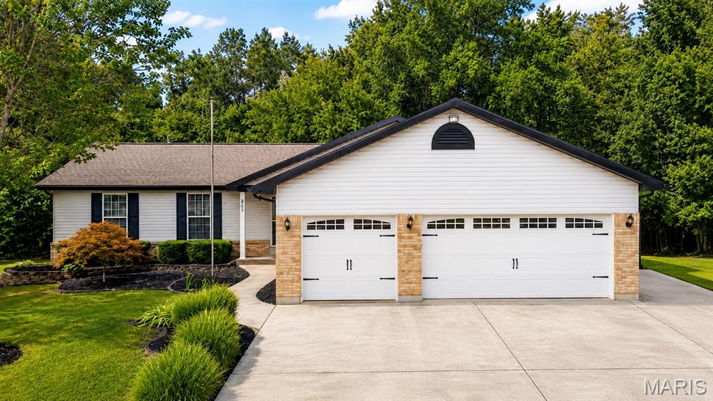 Welcome home to this well-maintained 4-bedroom, 3-bath home offering great curb appeal, featuring durable vinyl siding with a brick front exterior and a stylish brick mailbox, all set on a quiet cul-de-sac lot with beautifully landscaped grounds, a 3-car garage with updated garage doors, and a huge 4-lane driveway with room for RV parking. The home also includes a 200-amp electrical service and thoughtful updates throughout, along with a peaceful setting that backs to trees and a creek for added privacy! The updated kitchen features stainless steel appliances, a gas stove, microwave, and ceramic tile flooring. Fresh paint and new carpeting throughout the great room, hallway, and bedrooms give the main level a fresh, move-in-ready feel. The spacious primary bedroom offers a walk-in closet and private bath with new flooring, a tub, and separate shower. The finished lower level provides even more room to spread out, featuring new carpeting in the family room and bedrooms, a huge wet bar, gas fireplace, and a cedar closet tucked conveniently under the stairs. Step outside and enjoy the 15' x 20' deck and patio, perfect for relaxing or entertaining while taking in the natural backdrop of trees and the creek.With 4 bedrooms, 3 full baths, generous living spaces, great storage, and numerous updates, this home has been lovingly maintained and is ready for its next owner!