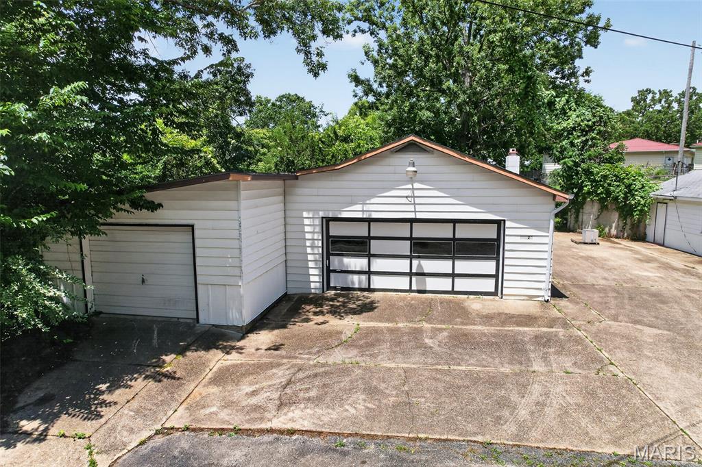 Unlock the potential of this unique multi-building property situated just off Historic Route 66 with quick and easy access to I-44! Offering excellent visibility and versatility, the first building features approximately 1,488 sq ft with multiple overhead garage doors, an overhead track system, a half bath, and 3-Phase electrical available—perfect for an  workshop, small business, or creative workspace. The second building includes approximately 549 sq ft with its own overhead garage door and is ideal for a future apartment build-out, storage for rental supplies, antiques, tools, or even a boutique flea market setup. With utilities currently disconnected and the property being sold as-is, this truly is a blank canvas ready for your vision. Bring your ideas and transform this flexible Route 66 location into your next income-producing opportunity! Square footage and measurements are approximate (DSC-8001).
