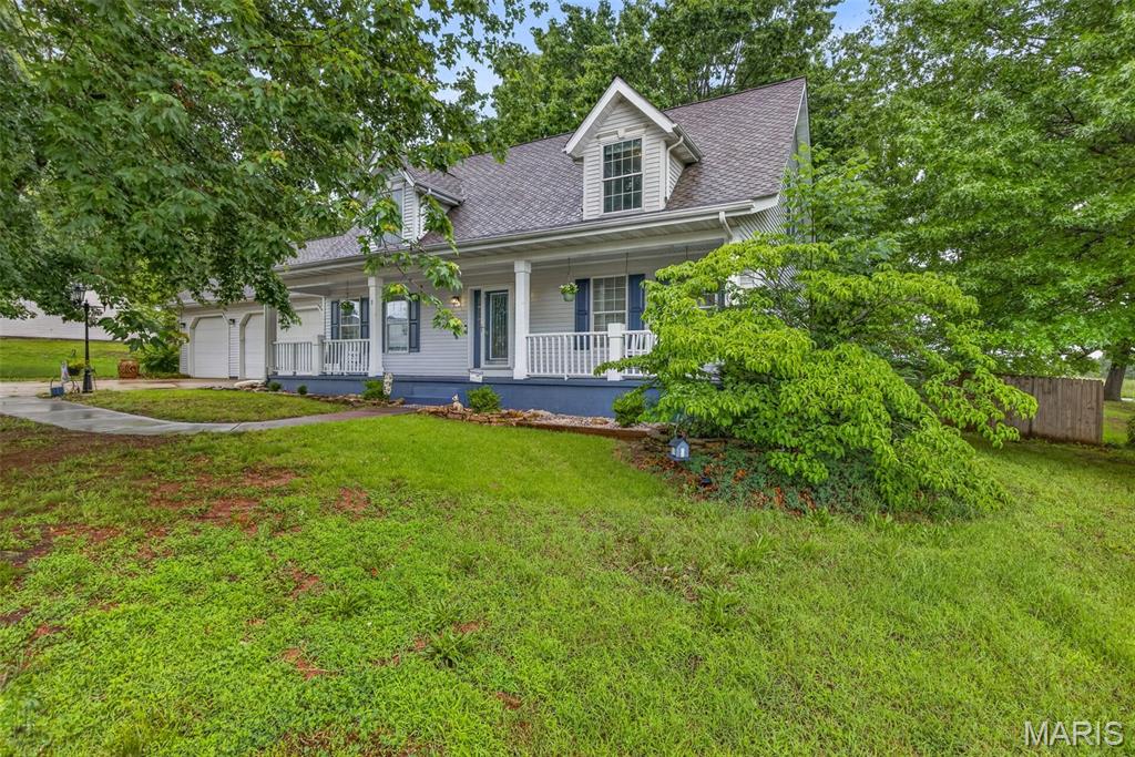 This beautiful Cape Cod style home is the one you've been waiting for located in Hunters Ridge. Featuring 3 bedrooms and 2 baths, this thoughtfully designed home is loaded with extras that must be seen to be appreciated. The living room boasts beautiful built-in shelves and storage, while the kitchen impresses with Corian countertops and matching backsplash. The main floor master suite offers a generous 6x10 walk-in closet. Upstairs, both bedrooms provide access to an incredible 45-foot storage area spanning the entire length of the home — plus additional storage accessible from the upstairs bath. The oversized 3-car garage features a slot deep enough for a boat, plus a finished 19x7 room with baseboard heat and a woodworking bench — the perfect man cave or hobby shop! Outside, enjoy a fully fenced backyard offering wonderful privacy. Every detail has been carefully considered in this one-of-a-kind home!