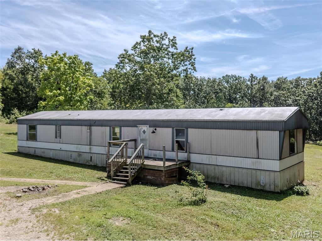 Opportunity awaits on 8 acres in Northern St. Francois County! This manufactured home is ready for someone with the vision and skills to bring it back to life. The interior requires extensive renovation, making this a great opportunity for a handy buyer, investor, or weekend DIY enthusiast looking to build significant sweat equity. The property also offers flexibility for the future. Rehab the existing manufactured home, or remove it and take advantage of the established site to build a new home of your own. A 20x30 detached garage with concrete floors and electric is already in place, providing plenty of room for vehicles, tools, a workshop, or storage. The property is mostly wooded with some cleared ground around the homesite. With no close neighbors, you can enjoy a peaceful country setting while still being conveniently located just a short distance from Hwy 67, providing easy access and a manageable commute toward the St. Louis area. If you're looking for acreage, privacy, a shop, and a property where your work can add real value, this one has plenty of potential.