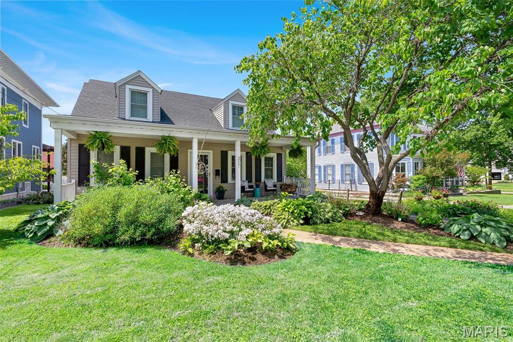 LOCATION, LOCATION, LOCATION! If you’re looking for a home within walking distance of Downtown Kirkwood, this is the one. Welcome to this beautiful 5-bedroom, 4-bath Cape Cod-style home in the heart of Kirkwood.  A large, inviting covered front porch sets the tone as you enter the home. Inside, the front sitting room features a charming wood-burning fireplace that flows seamlessly into the dining room, creating a warm and welcoming atmosphere. Down the hall you will find two bedrooms and a full bathroom.  The kitchen opens to a spacious living room, perfect for entertaining, with additional seating at the bar for guests. Just off the kitchen is a convenient mudroom and pantry. The second floor offers a loft area which provides flexible living space, along with two generously sized bedrooms, the 2nd full bath and a second-floor laundry room. The primary suite offers a walk-in closet, walk-in shower and relaxing Jacuzzi tub.  The partially finished basement provides even more living and storage space, complete with the 4th full bathroom. Step outside to an incredible backyard patio featuring a fire pit and the ultimate bonus a charming “She Shed” ready for outdoor entertaining or relaxation.  Enjoy being just a short walk to all the restaurants and shops in Downtown Kirkwood, the Kirkwood Community Center and pool. This is a home you won’t want to miss!