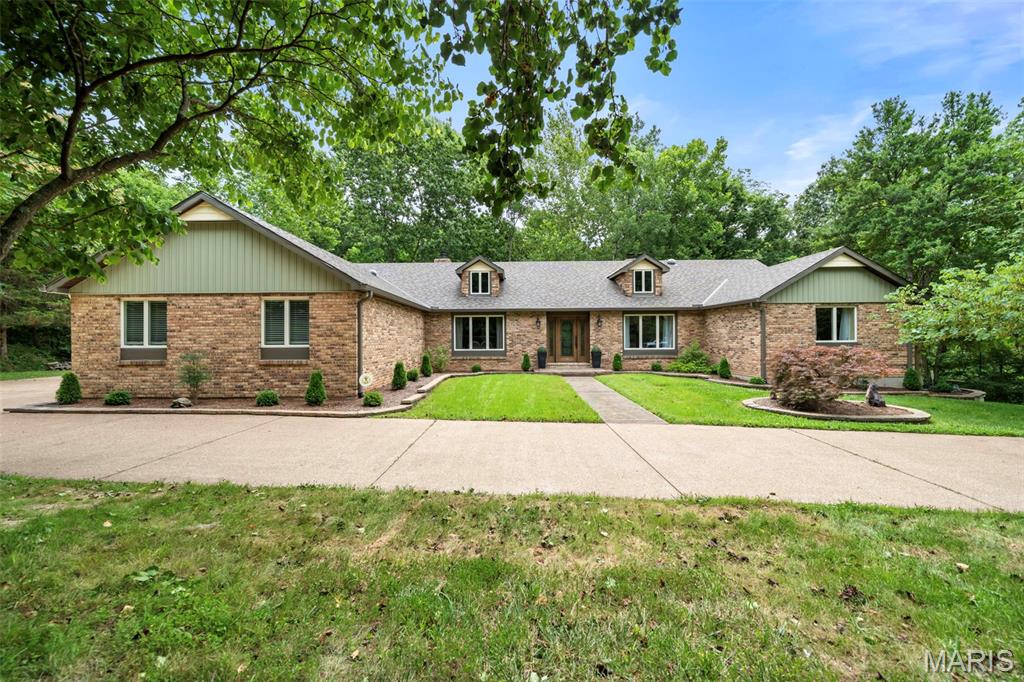 Welcome to this beautifully renovated sprawling ranch situated on 3+ picturesque acres! Offering 12 rooms to include 3 spacious bedrooms, 3 full baths, and 1 half baths, this exceptional home combines generous living space with modern updates throughout. Nearly every major feature has been improved, giving you peace of mind and move-in-ready convenience. The beautiful trees and lush landscaping welcome you. The stamped concrete walkway and porch lead you to the gorgeous leaded wood doors with sidelights. Once inside you will appreciate the fresh, updated interior featuring new flooring throughout the main level, stylish light fixtures and fresh paint.  Walk straight ahead into the formal living room with huge bay window, wood floors, and wood burning fireplace with built ins. The family/hearth room offers another fireplace, wood floors, and walk out to the new deck. The spacious kitchen has a huge skylight, large breakfast bar with granite counters, two pantries, stainless appliances, fireplace and new doors to walk out to the cedar treated wood deck. Spacious formal dining room for your Sunday night dinners. Main floor laundry and updated half bath off the kitchen. The primary bedroom has a fireplace, 2 walk in closets, primary bath with dual vanities and a small deck. Two additional bedrooms and a huge full bath are on this wing of the home. The walk out lower level showcases a huge rec room with a built-in bar and wood burning stove.  Two additional bonus rooms, one connects to a full bath. There is also a huge storage room with a side walk out.  Recent upgrades include a new roof, siding, windows, gutters and downspouts, air conditioner, front porch, sidewalk, two patio doors, cedar-treated decks, landscaping, flooring, epoxy garage floor, outdoor lighting, and security cameras.   The oversized garage boasts durable epoxy flooring, adding both function and style. Step outside to enjoy the expansive property from the newly built cedar decks, offering the perfect setting for relaxing, entertaining, or simply taking in the peaceful surroundings. With countless improvements already completed, this impressive ranch offers the perfect blend of quality craftsmanship, modern comfort, and country-like privacy—all while remaining conveniently located near shopping, dining, and major highways. Move in, unpack, and start enjoying everything this exceptional property has to offer!