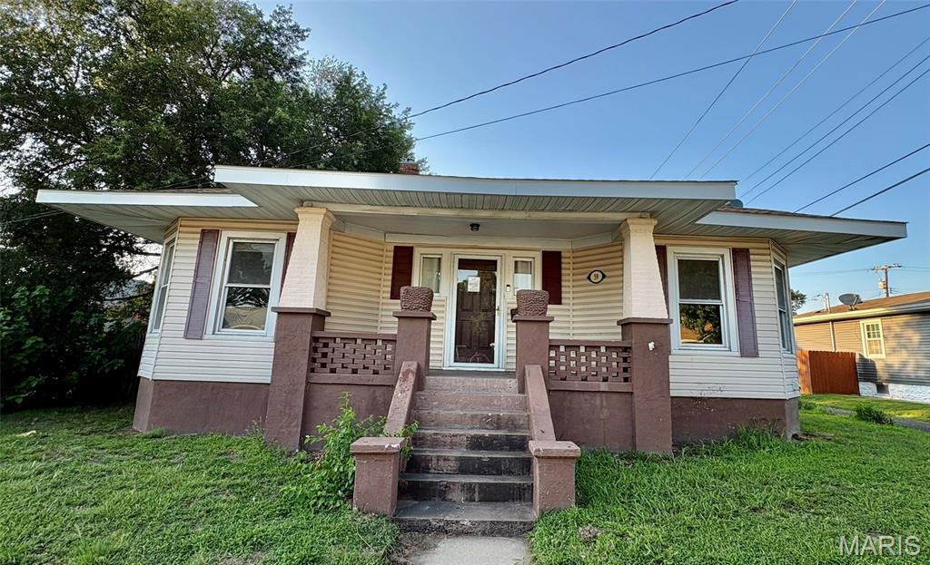 Opportunity awaits with this 2-bedroom, 1-bath home full of character and potential! Featuring wood floors throughout the main level, a welcoming foyer with built-in bookcases, and a spacious primary bedroom with a sliding barn door to the closet. The finished basement offers a non-conforming sleeping area, a 3/4 bath with tile flooring, and a large bonus room ideal for a family room, recreation area, or home office. Outside, enjoy the expansive covered front porch, fenced backyard with patio, and a detached 2-car garage with an attached potting shed, hobby space, or additional storage, conveniently accessed from the alley. This fixer-upper is ready for your vision and a little TLC to make it shine!