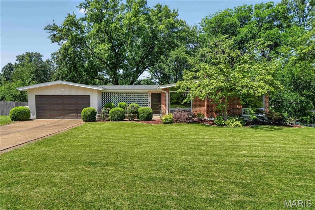 Welcome home to this beautifully maintained mid-century ranch offering 3 bedrooms, 3 full bathrooms, and a finished walk-out basement on an expansive, fully fenced 0.42-acre lot. The light-filled family room flows seamlessly into the dining area and features large windows, warm wood flooring, and a cozy fireplace, creating an inviting space for everyday living and entertaining. The updated kitchen offers plenty of cabinetry and workspace, along with a sunny breakfast area perfect for casual dining. Down the hall, you'll find three comfortable bedrooms with hardwood floors, including a primary suite with full bath and an updated hall bath. The finished walk-out lower level provides exceptional flexibility with a generous recreation room, a third full bathroom, and additional finished spaces ideal for a home office, workout room, hobby area, or playroom. Step outside to enjoy the covered breezeway overlooking the large, private backyard, offering plenty of room for outdoor entertaining, gardening, or simply relaxing. Located in a desirable neighborhood with a community pool just a short distance away, this home combines timeless character, modern updates, and outstanding indoor and outdoor living spaces. Roof 2022, Front door and Garage door 2025, new carpeting and kitchen tile 2025, breezeway tile 2021, hall bath 2020, basement remodel including new bathroom 2015