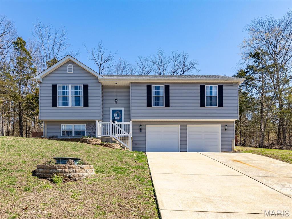 OPEN HOUSE THIS SUNDAY JUNE 28th 1-3pm!! (Go to Country club gate & Gate attendee will let you in through, take to Duffer Drive, GPS friendly from there).  Welcome to your Home Sweet Home and Vacation 24/7 with PRIVACY all around. It's pretty AMAZING to get such a great price in this Raintree subdivision & Sellers are motivated! - This BEAUTIFUL 4 BEDROOMS & 2 FULL BATHS with open floor plan welcomes you with plenty of natural light & a HUGE oversized garage!  Relax & unwind with your fully stocked custom-made movable bar & a huge new deep freezer that comes with the house!  Your main bedroom has your walk-in closet, as that is a must! All rooms have T.V. mounts as well already installed! The fenced in yard is perfect for entertaining and pets. Lake is so close & walkable to fish your cares away! Your private Home Sweet Home with breathtaking view surrounded by nature is on 1/2 an acre, surrounded by woods & privacy is what most people like in a subdivision, this one has it!  With white sandy beaches, 4 lakes, 18-hole golf course & golf shop, a boat launch, a HUGE saltwater pool with pool side bar & snacks, Country club W/ Restaurant, sports bar & fitness center.  The sought-after amazing Hillsboro school district is top notch!  A Raintree Gas Station Market & Grill is in front of subdivision open for your convenience. MAKE THIS HIDDEN GEM, YOUR NEW DREAM - BEFORE IT IS GONE!