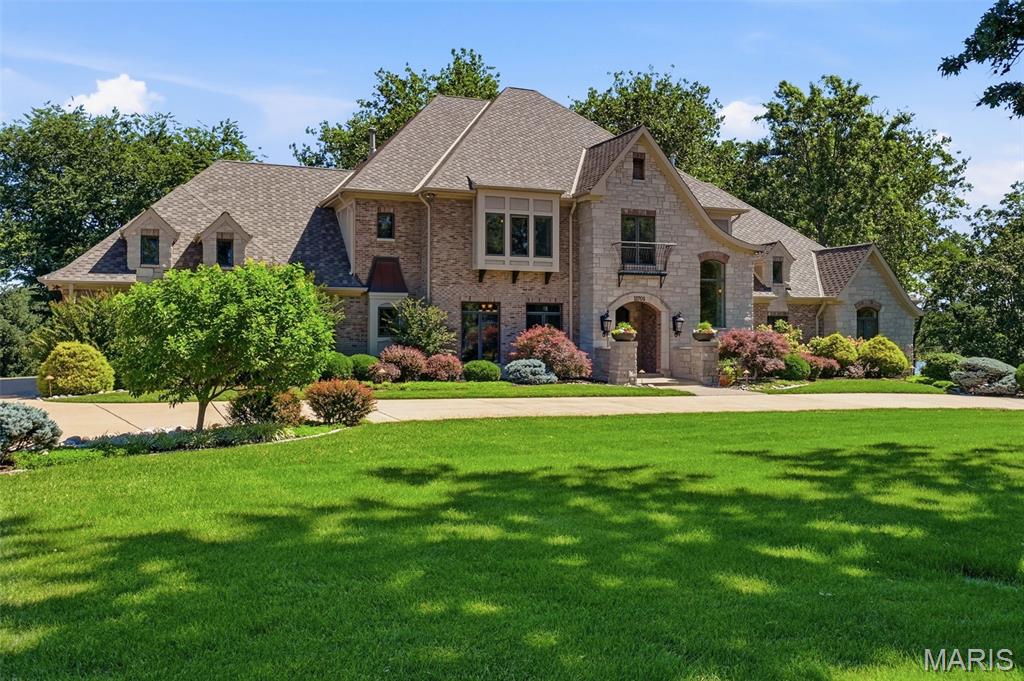 Welcome to 17701 Lakeshore Drive, a truly extraordinary lakefront estate offering an unparalleled lifestyle in one of the St. Louis region's most spectacular settings. Nestled along the shores of a breathtaking 20-acre private lake, this remarkable 5-bedroom, 7-bath residence showcases some of the most captivating water views imaginable, creating a year-round retreat unlike anything else on the market. Designed for both grand entertaining and everyday luxury, the home features beautifully appointed living spaces complemented by stunning lake vistas from nearly every room. The gourmet kitchen has been thoughtfully updated with top-of-the-line Wolf and Sub-Zero appliances, providing the perfect backdrop for both intimate family dinners and large-scale gatherings. Step outside to discover a resort-caliber saltwater pool overlooking the shimmering lake, an unforgettable setting for relaxing, entertaining, and enjoying spectacular sunsets. Inside, every amenity has been carefully curated for elevated living, including a private home theater, temperature-controlled wine cellar, and 3 ensuite bedrooms upstairs to accommodate family and guests with ease. Combining exceptional privacy, unmatched waterfront beauty, and world-class amenities, 11701 Lakeshore Drive represents a rare opportunity to own one of the most distinctive lakefront properties in the St. Louis area.