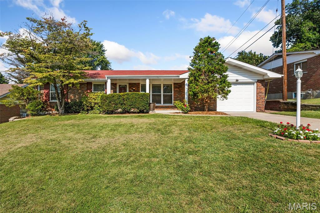 Welcome home to this 3-bedroom, 2.5 bath ranch in St. Charles! The welcoming covered front porch greets your guests and is the perfect spot to enjoy your morning cup of coffee!  The main level of this home has been freshly painted and has brand new carpet installed in August 2026.  The spacious sunken living room is bright and welcoming, with three windows that provide abundant natural light. The separate dining room features a door that leads to the backyard-perfect for indoor/outdoor entertaining! The kitchen features a stainless steel french door refrigerator, gas range, built-in microwave, and a double sink with a window above overlooking the backyard. Just off the kitchen is the family room that features a woodburning fireplace and a second door leading to the backyard.  Two spacious bedrooms share a full hall bath and the primary suite features a half bath. The partially finished lower level provides additional living space with a rec room, sleeping area, and full bath- perfect for guests, hobbies, or a home office. Outside, the fully fenced level yard offers plenty of room for play or entertaining. If you are a gardener, there are already garden beds ready to be put to use! A one-car garage provides additional parking or storage space. Nestled between Highways 370 and 70, this home has easy access to shopping, dining, and is just minutes from Main Street St. Charles! Make your appointment today!