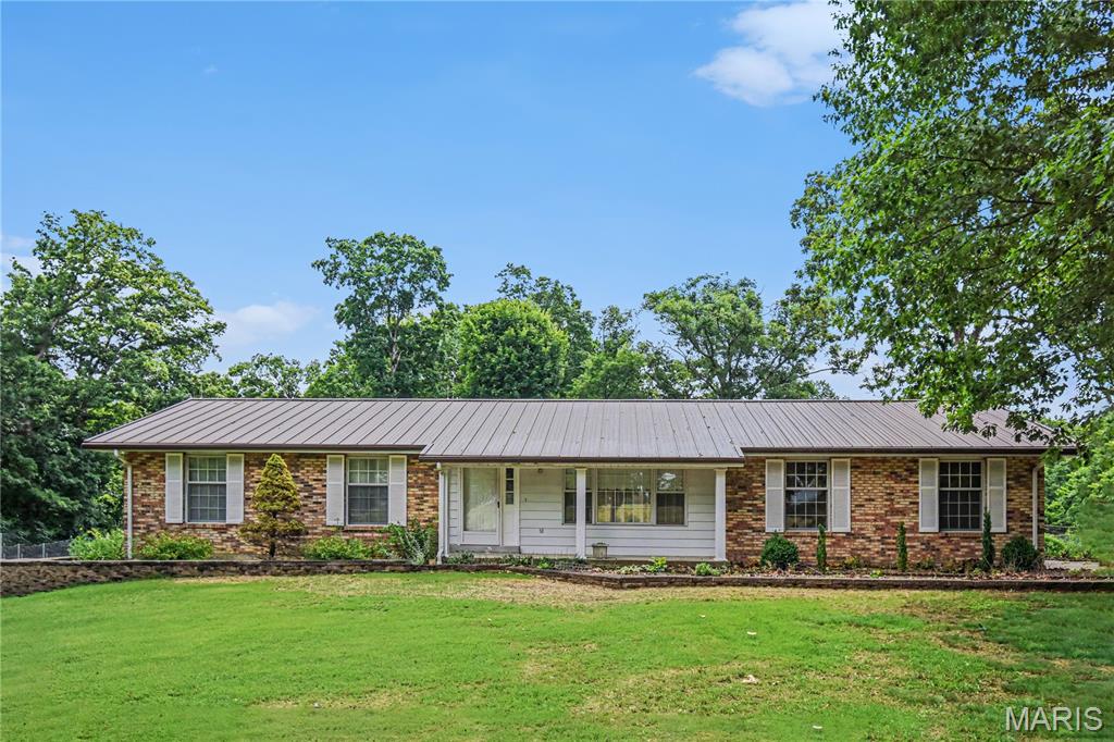 NEW PRICE! SELLER IS MOTIVATED! 20 acres total and a lot of potential! Please see both tax records! 5520 Highway T and  Mo-t in tax records! Tax ID 1-0010-S034-00-0011.0000000. Parcel D is 10010S0340000011 0000000. 
Discover the rare combination of acreage, privacy and potential at 5520 Highway T in Augusta! Situated on a total of 20 rolling acres, this property offers endless possibilities for those seeking a private country retreat, hobby farm, recreational property or future estate setting. The additional acreage creates room to explore trails, enjoy nature, hunt, build additional structures or clear select areas to capture scenic ridge-top views and stunning sunsets.  
The existing 3-bedroom, 2-bath ranch home provides a solid foundation for your vision. With over 1,700 square feet on the mail level, a spacious family room addition, walk-out basement and attached 2 car garage, the home is ready for updates and customization to create the modern country residence you've always wanted. Renovate at your own pace while enjoying the peaceful setting and exceptional land surrounding you. Bring your vision and unlock the full potential of this exceptional Augusta property. House is all electric, however there is an outside wood-burning boiler that can heat the house heating and water heater. There is a large shed and some areas near the house are fenced in to keep your pets safe!