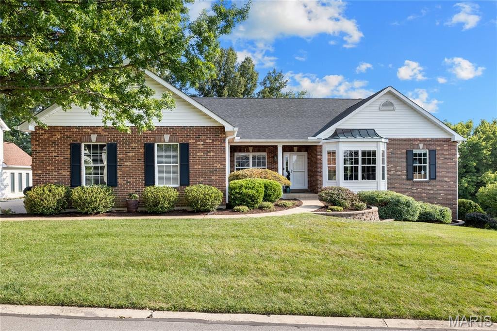 Enjoy carefree living at its finest in this exceptional brick cluster home located in beautiful Whitmoor Country Club. Recent updates include newer vinyl siding & roof and low maintenance deck. Inviting covered porch entrance leads to vaulted foyer, formal dining room framed by arched entryways and spectacular great room highlighted by floor-to-ceiling stacked stone fireplace. Designer kitchen with white cabinetry, granite countertops, premium stainless steel appliances & center island adjoins breakfast room with convenient planning center & pass-through wet bar and light-filled sunroom that overlooks the 18th hole on the South course. The spacious primary bedroom suite offers an appealing retreat with wide bay window & luxury bath with shower spa. 2 Generous-sized additional bedrooms & hall full bath complete the main floor living quarters. Lower Level entertainment space includes recreation room with wet bar & game room plus 4th & 5th bedrooms & full bath. Atrium doors open to outdoor living space with composite deck and covered & open patios surrounded by landscaped gardens.  Golf community lifestyle with access to clubhouse, pool, tennis courts, fitness center & 36-hole championship golf course.